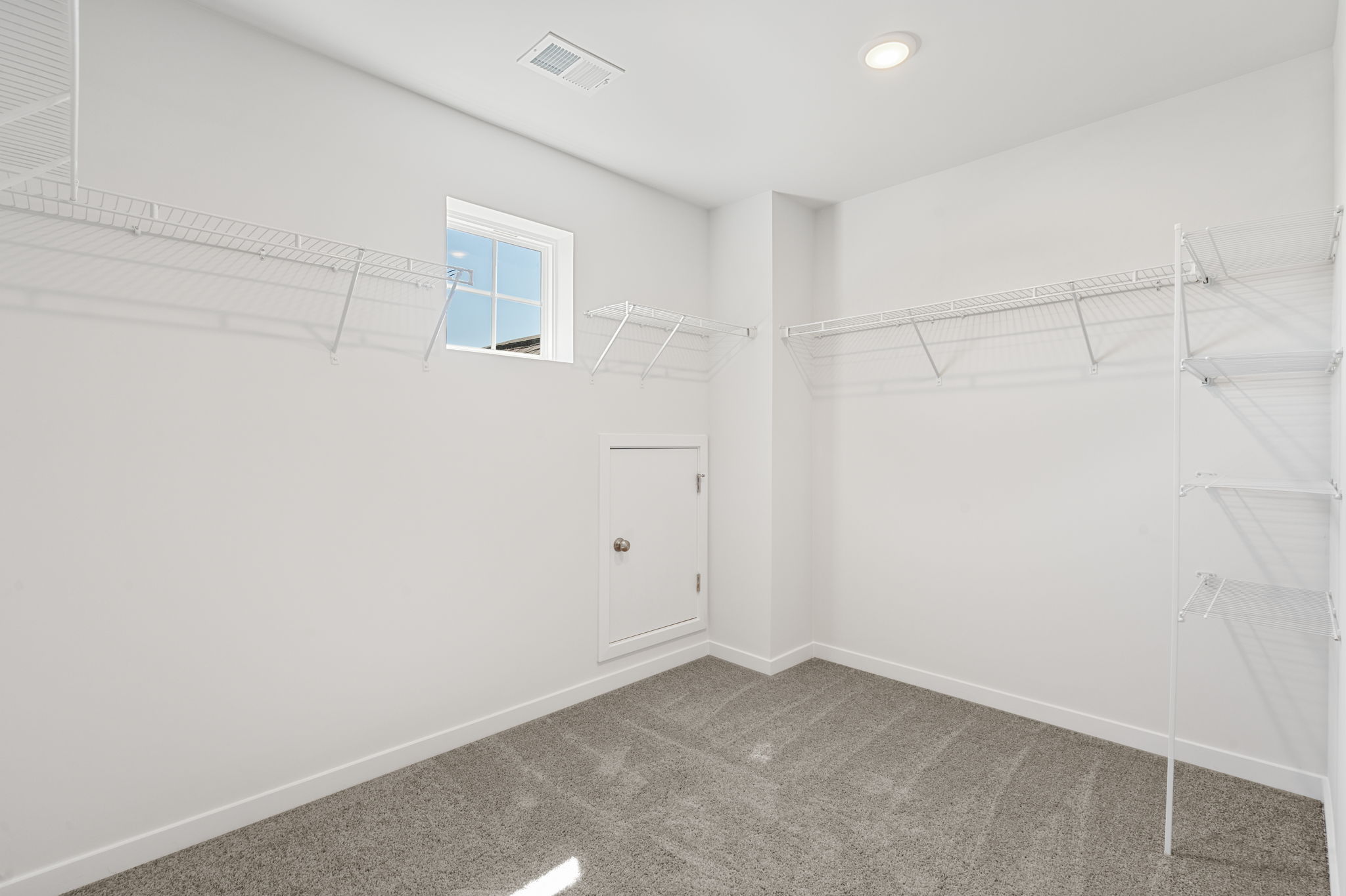 A room with white walls and a window.