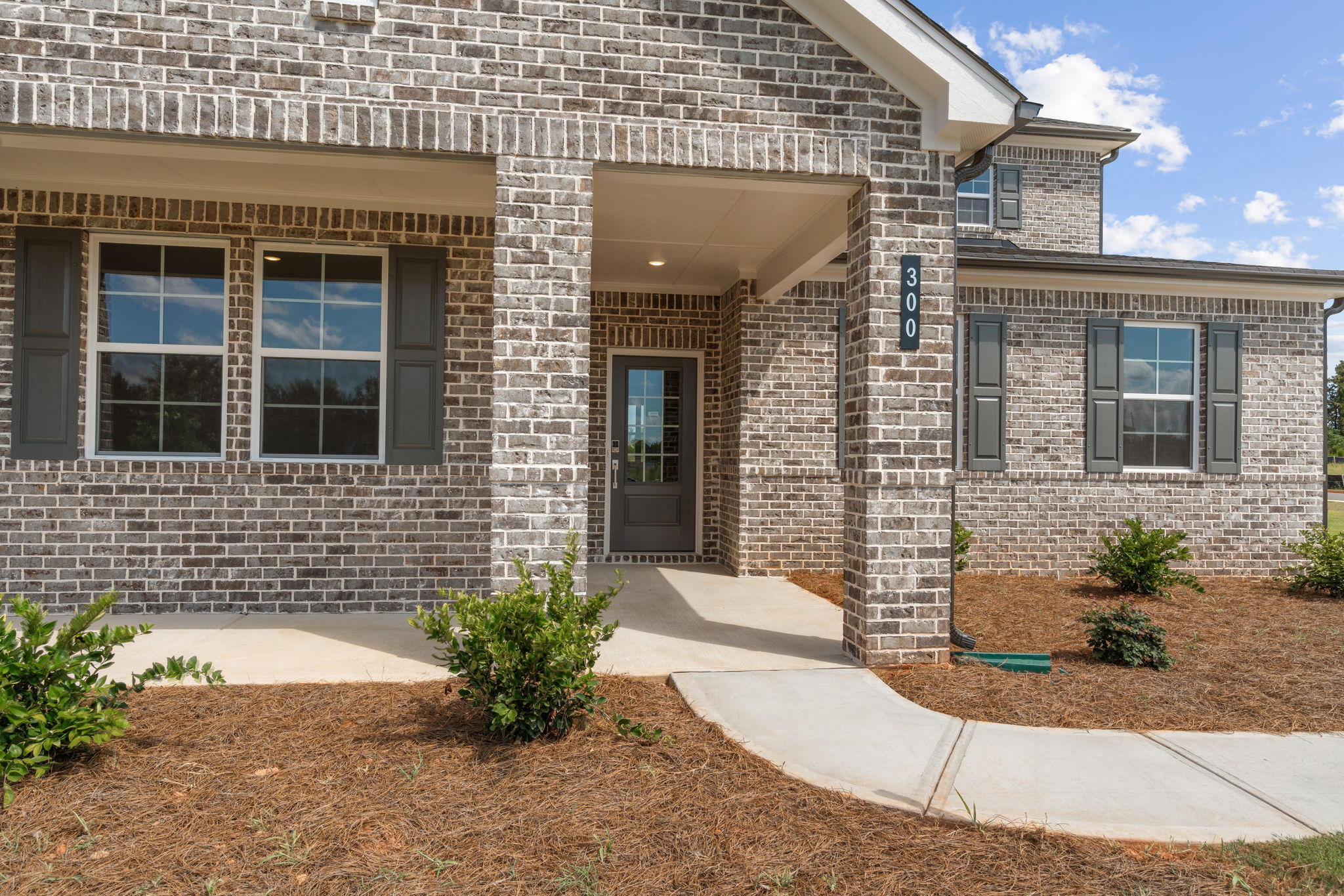 A brick building with a driveway.