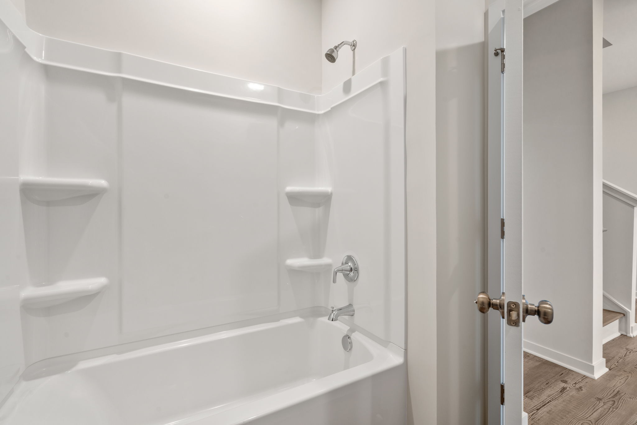 A bathroom with a bathtub and toilet.