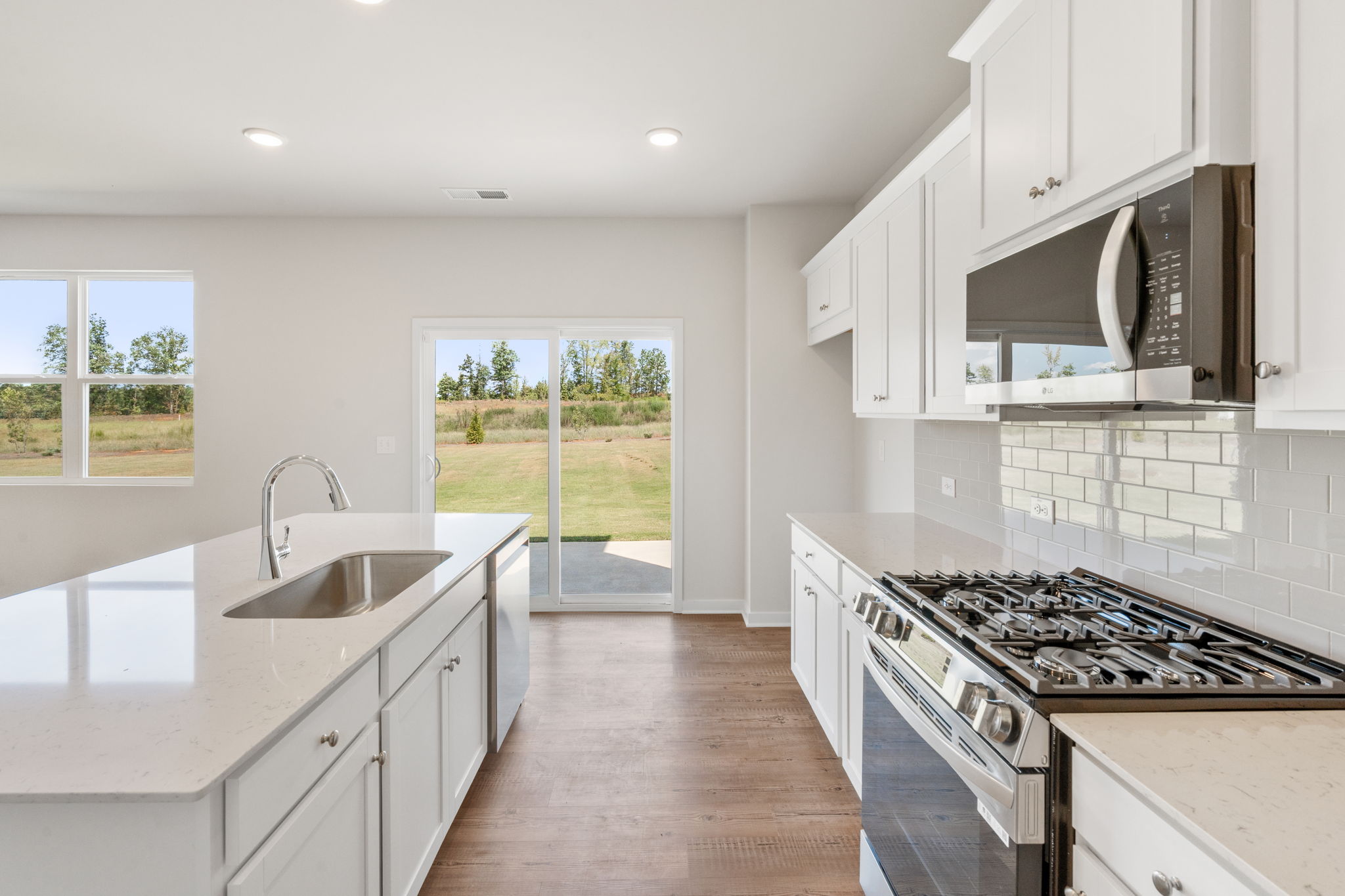 A kitchen with white cabinets.