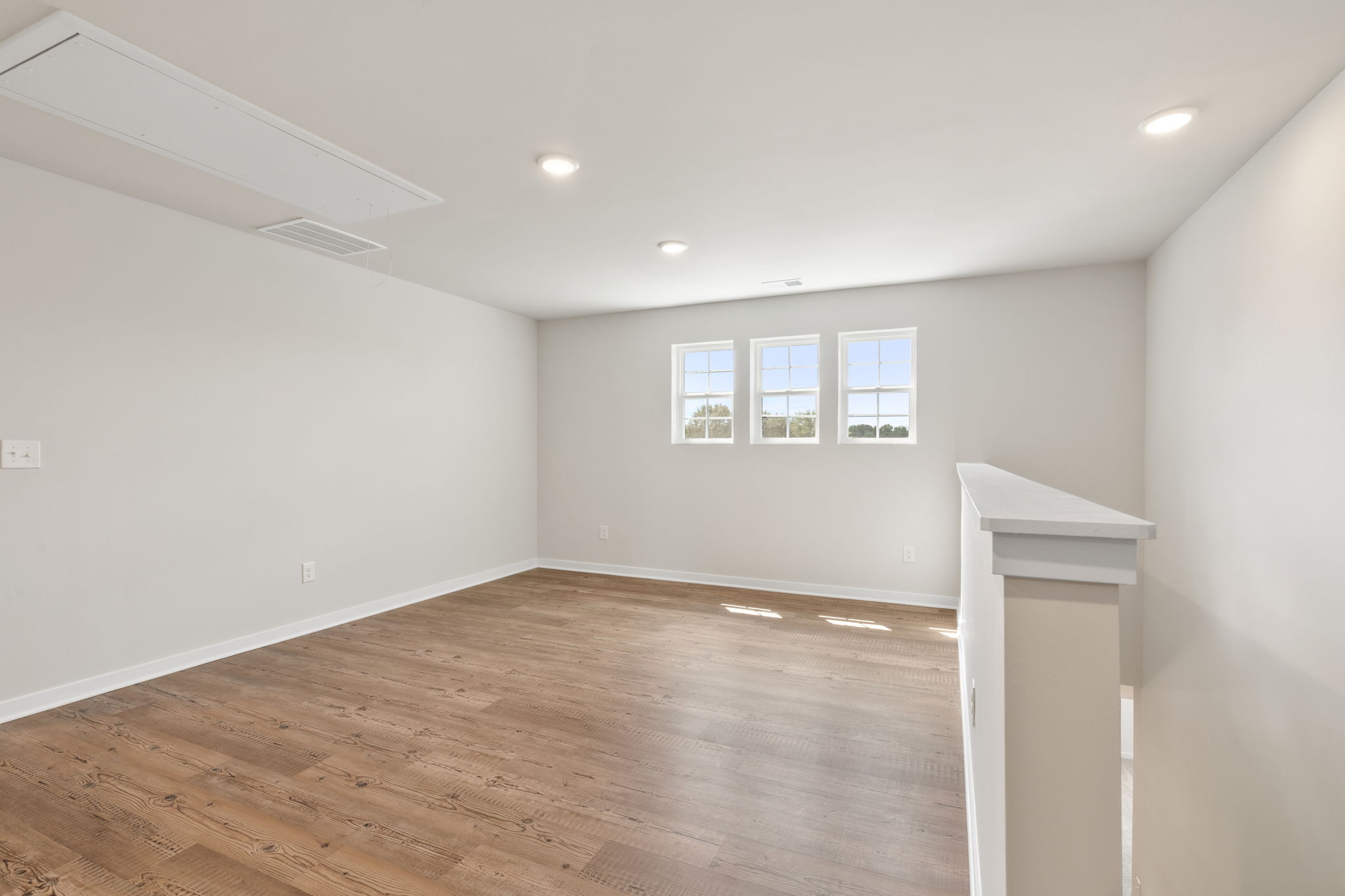 A room with a wood floor and a wood floor.