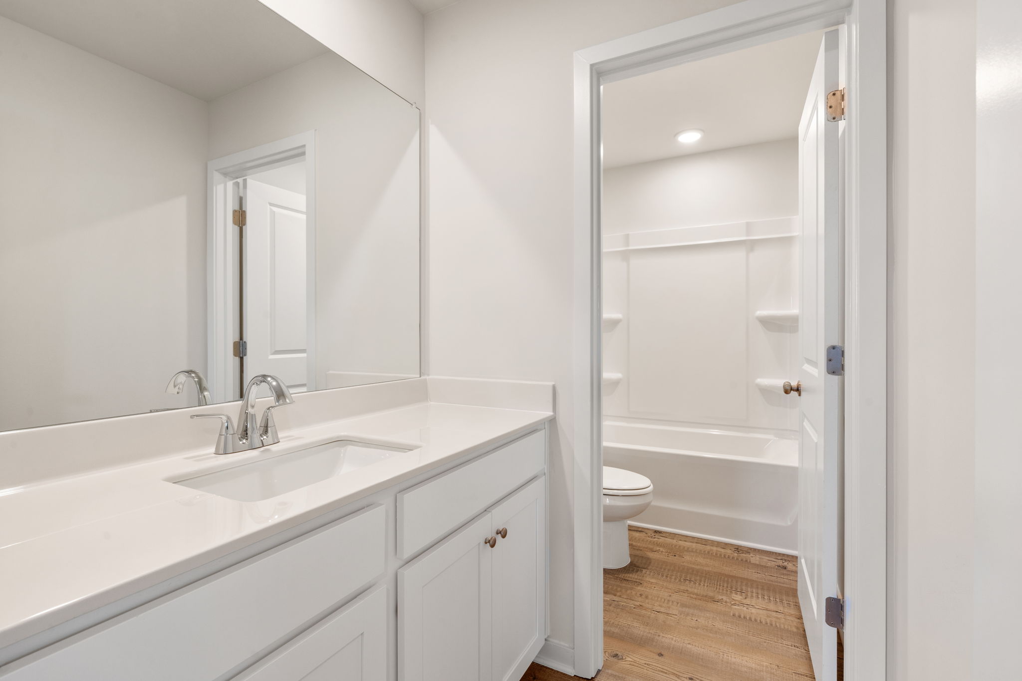 A bathroom with a sink toilet and shower.
