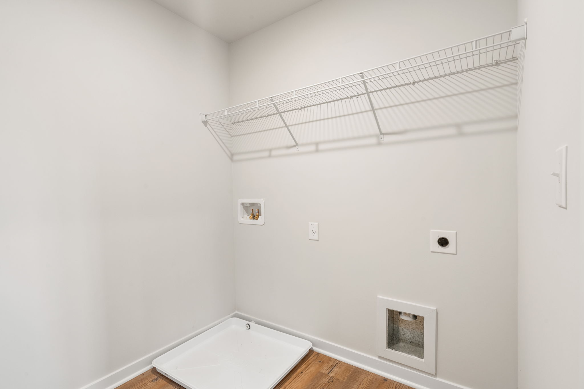 A white bathroom with a tub.