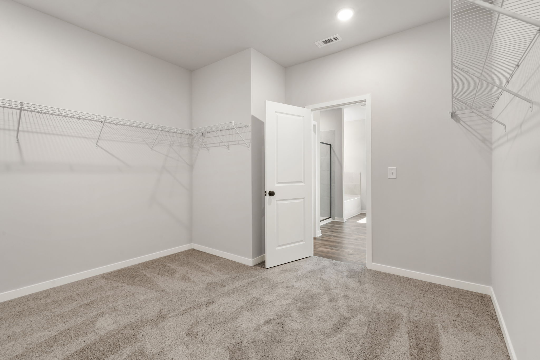 A hallway with white walls.
