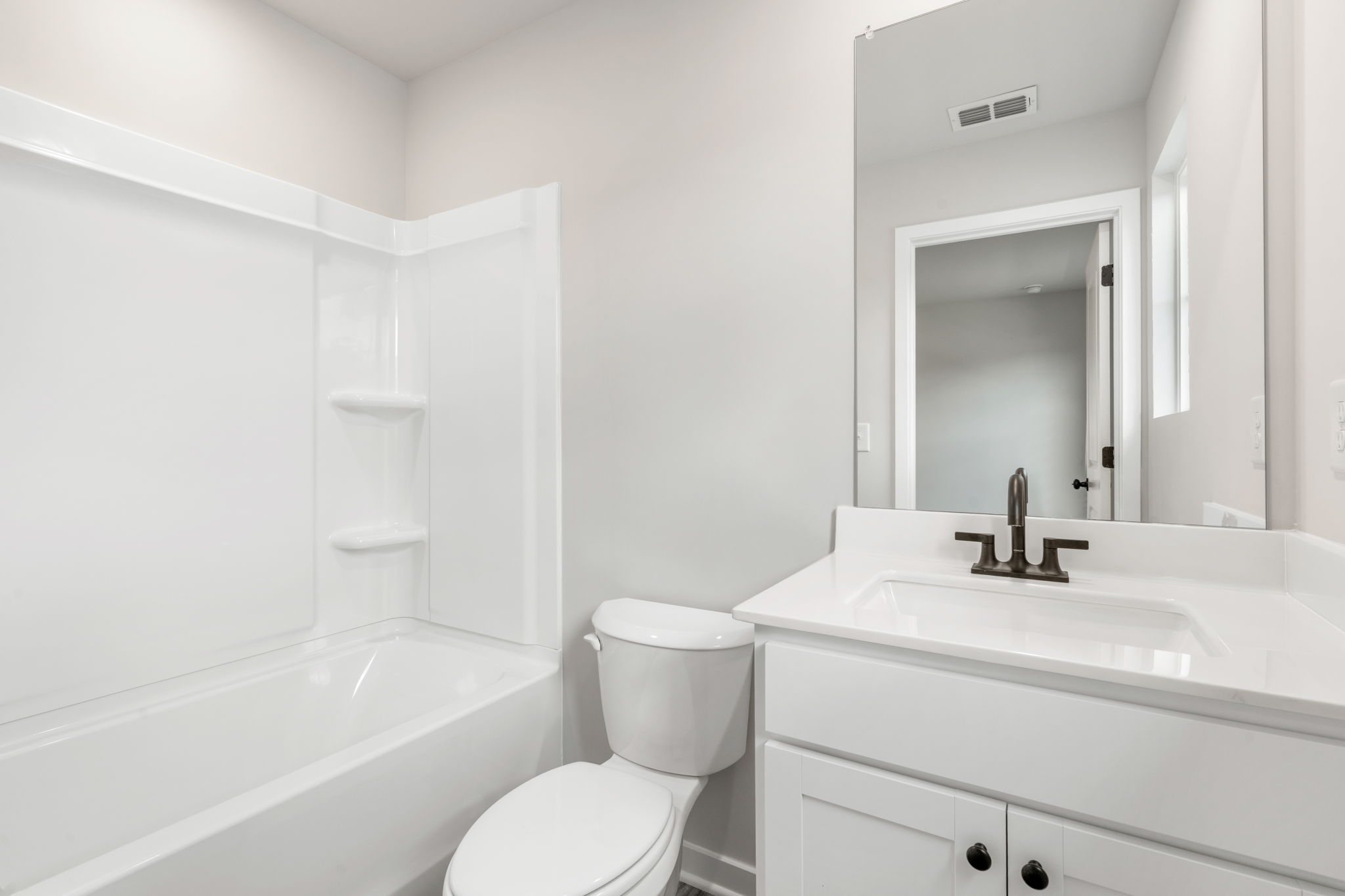 A bathroom with a tub toilet and sink.