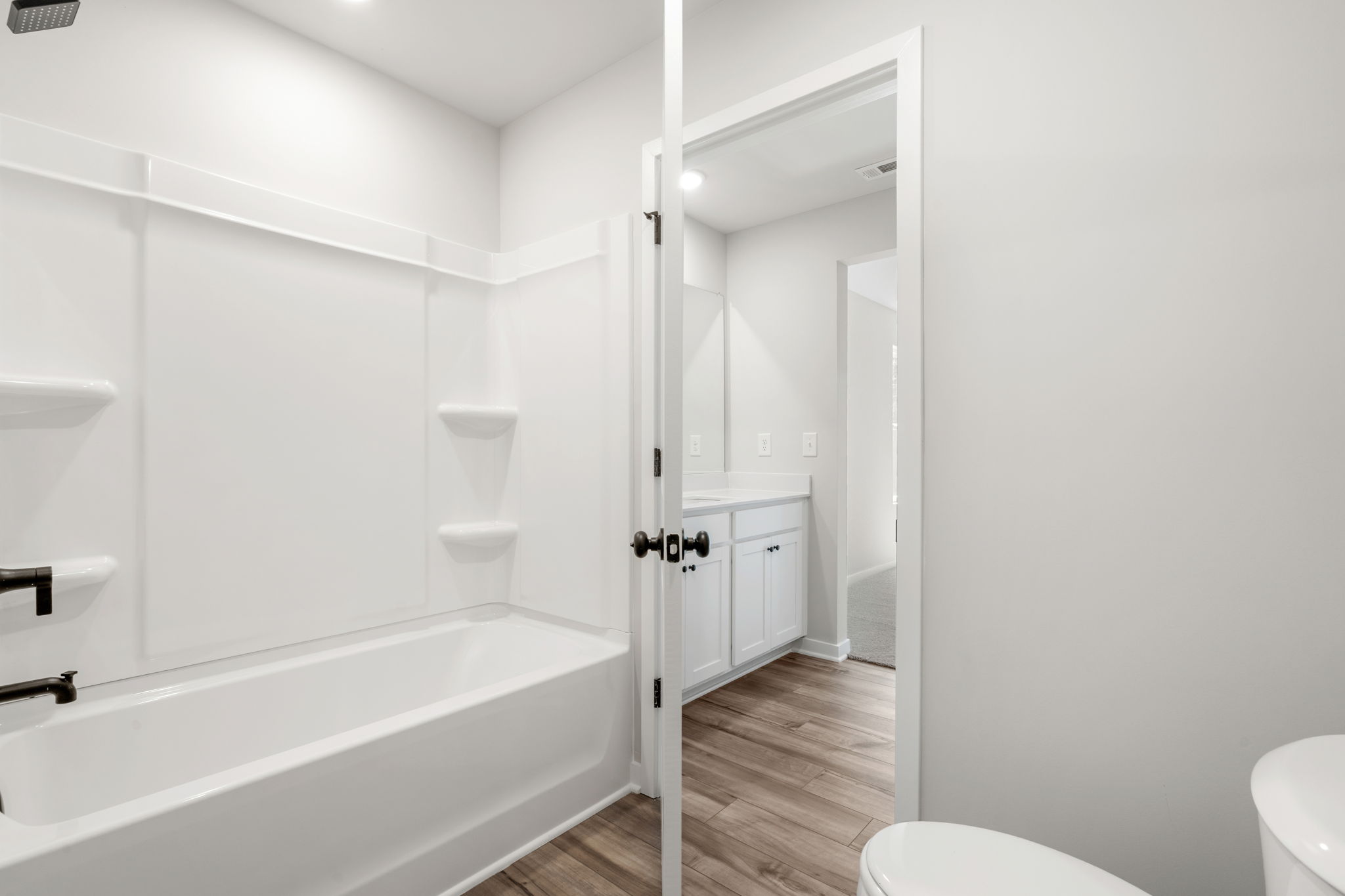 A bathroom with a tub toilet and sink.