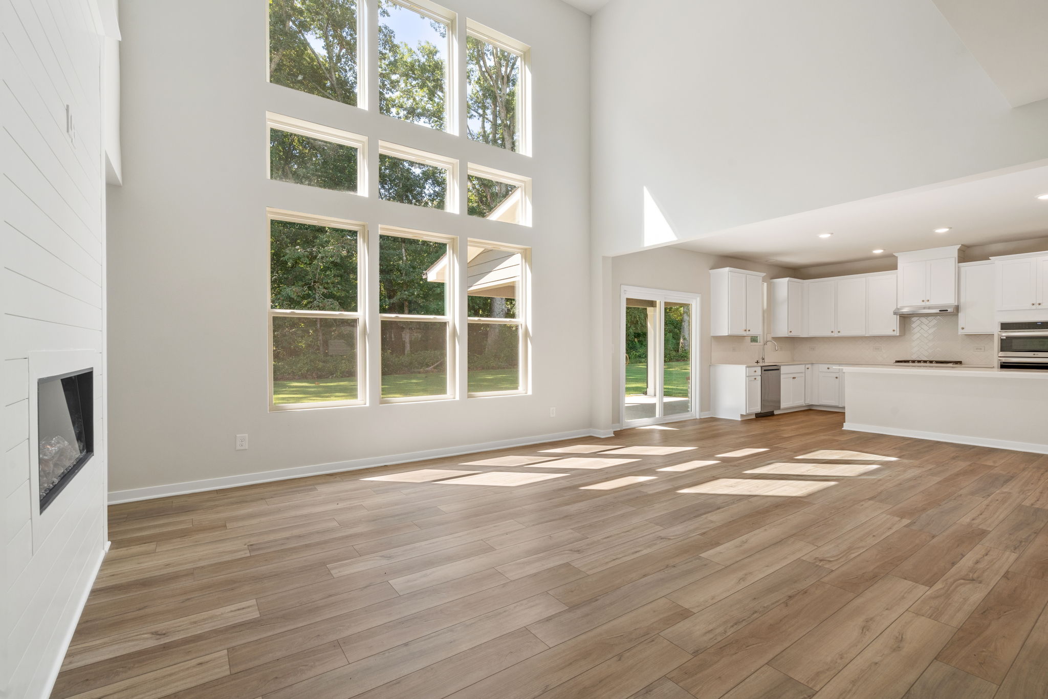 A room with a wood floor and a window with a wood floor.