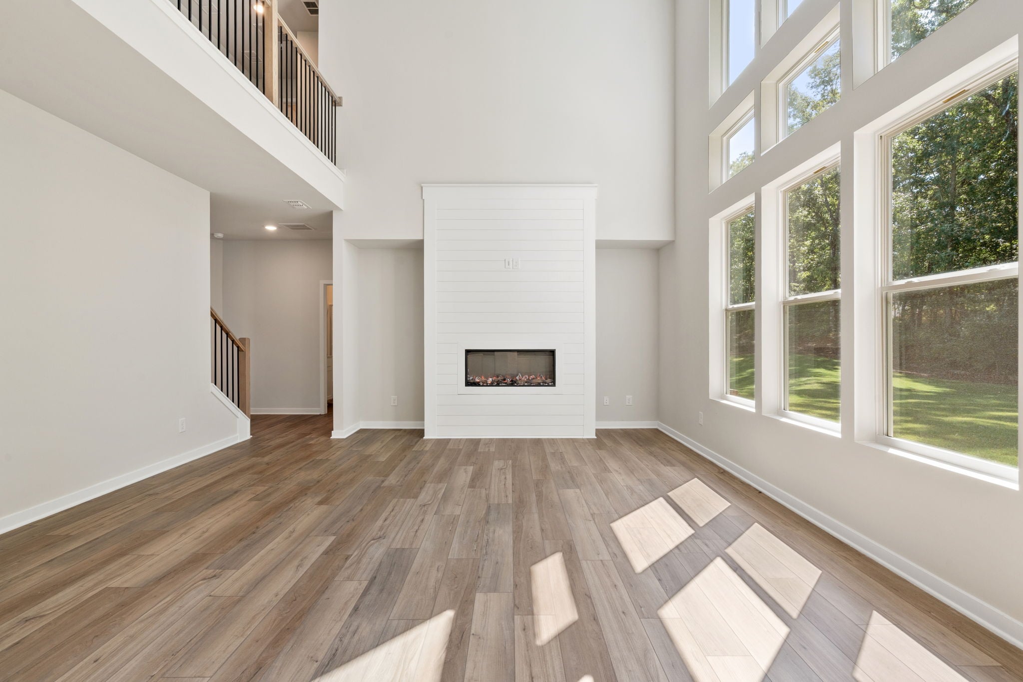 A room with a fireplace and windows.