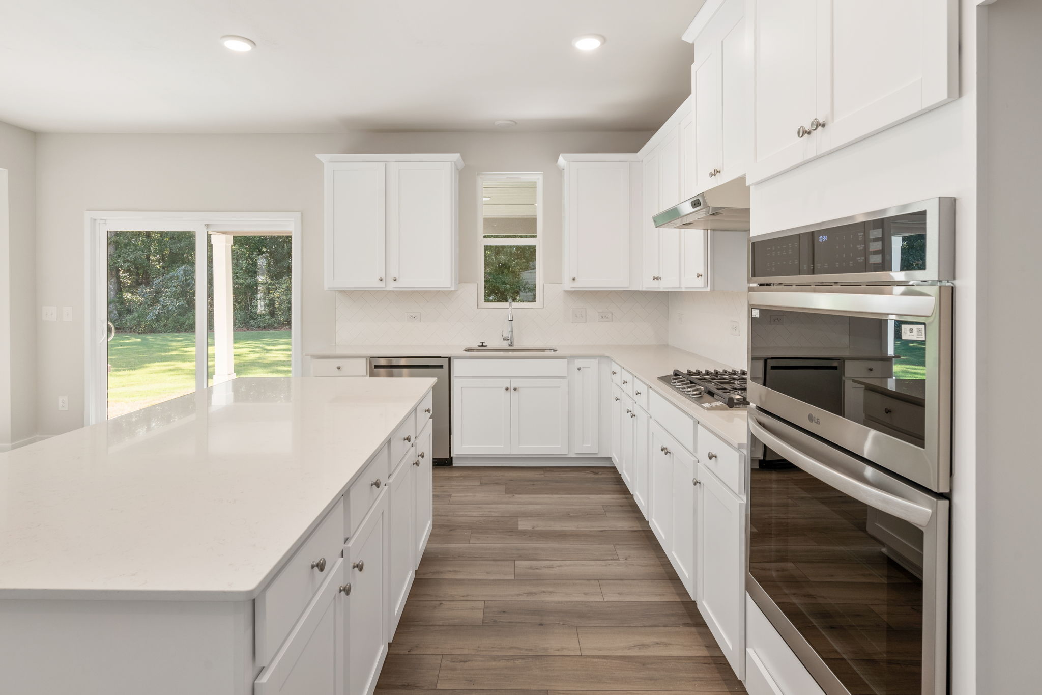 A kitchen with white cabinets.