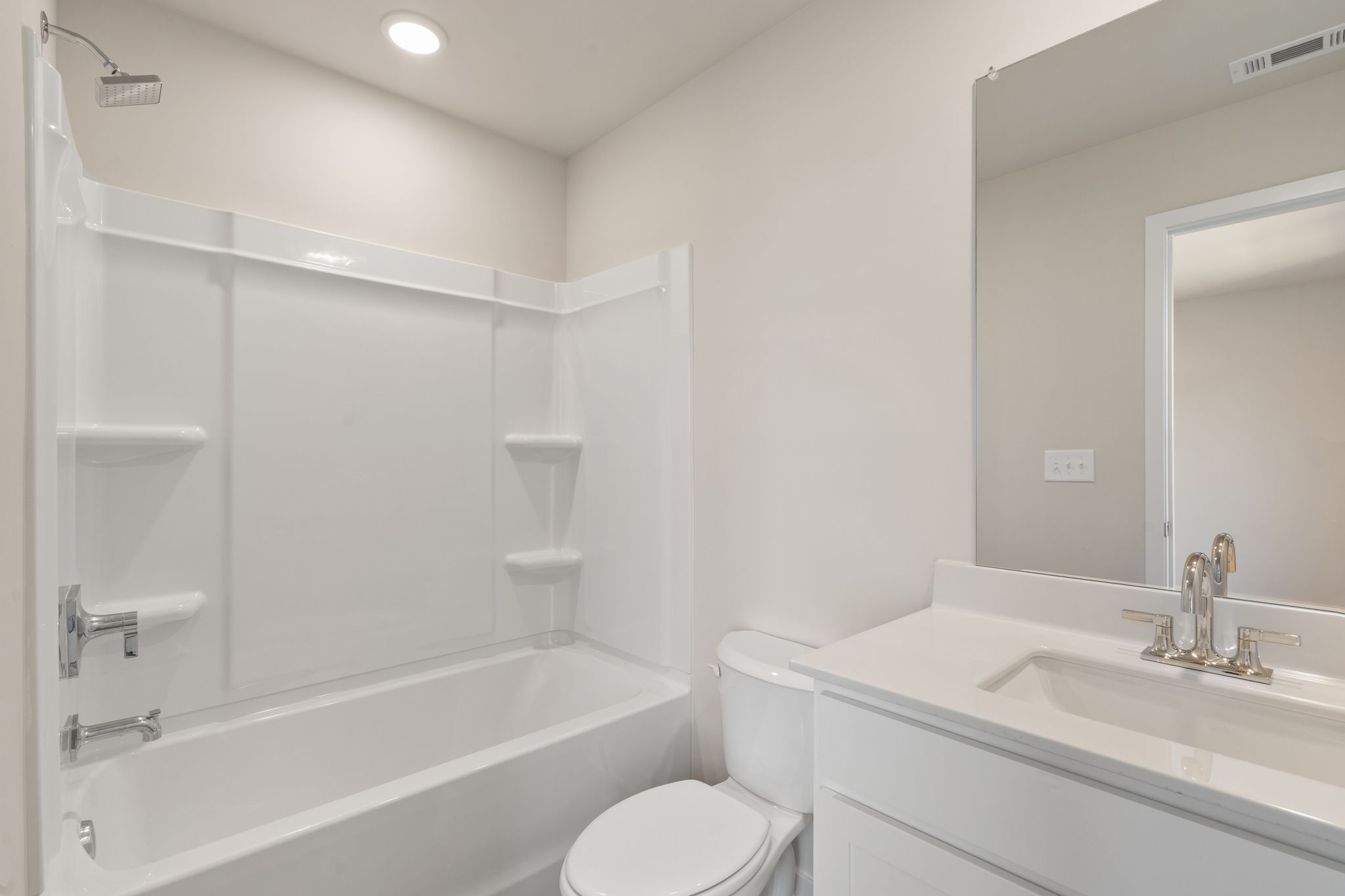 A bathroom with a tub toilet and sink.