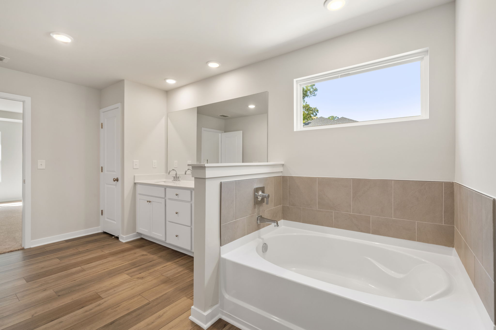 A bathroom with a tub and sink.