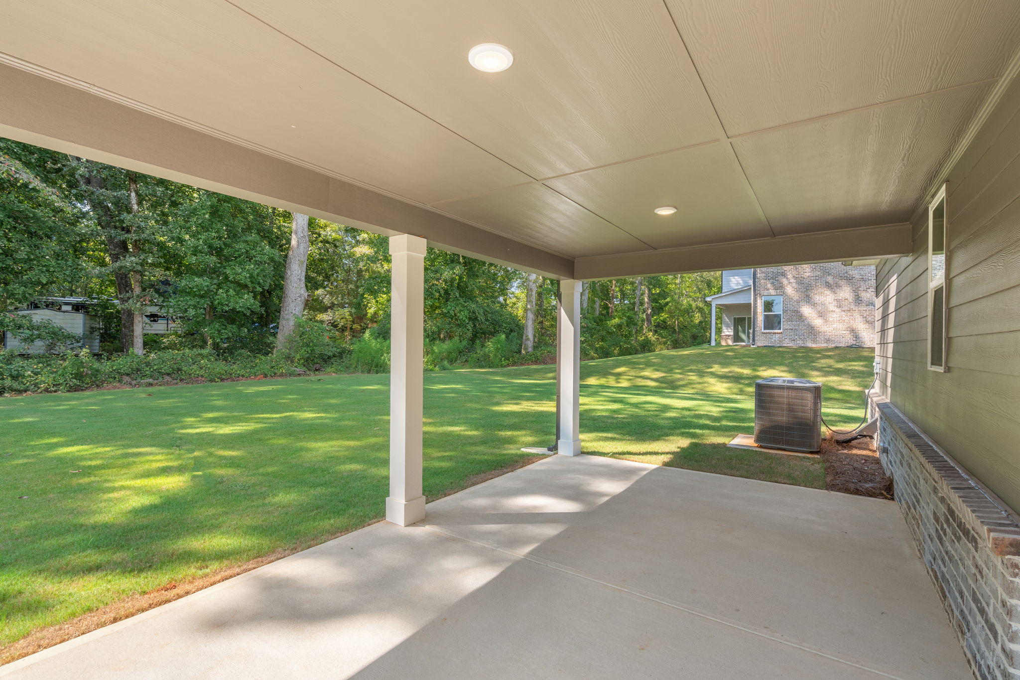 A walkway with grass and trees.