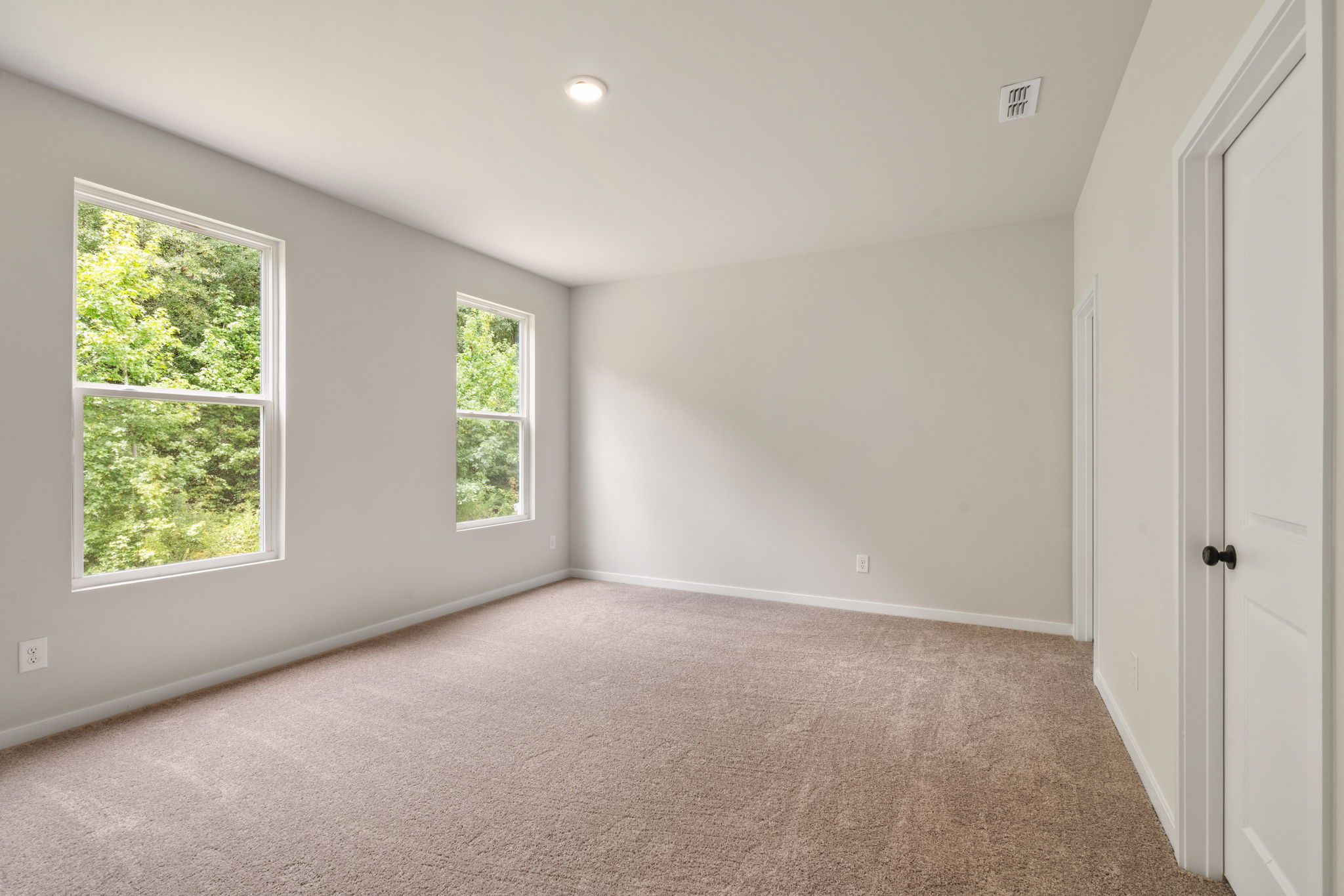 A room with a window and a door.