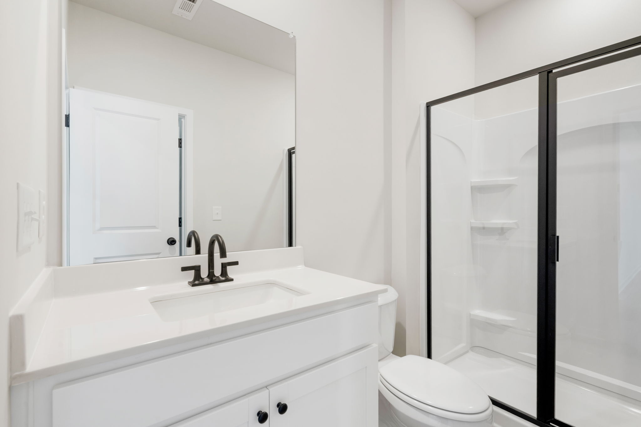 A bathroom with a glass shower.