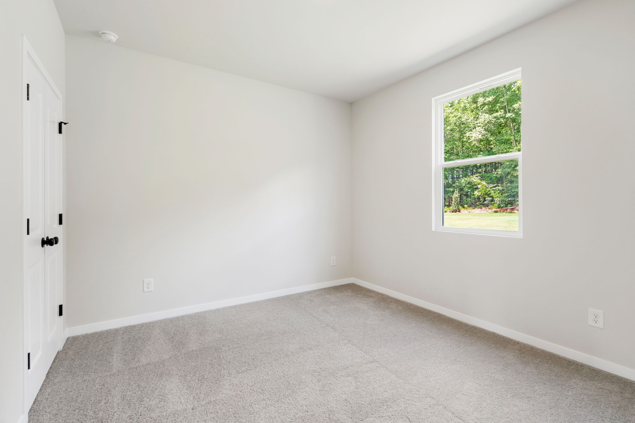 A room with a window and a door.