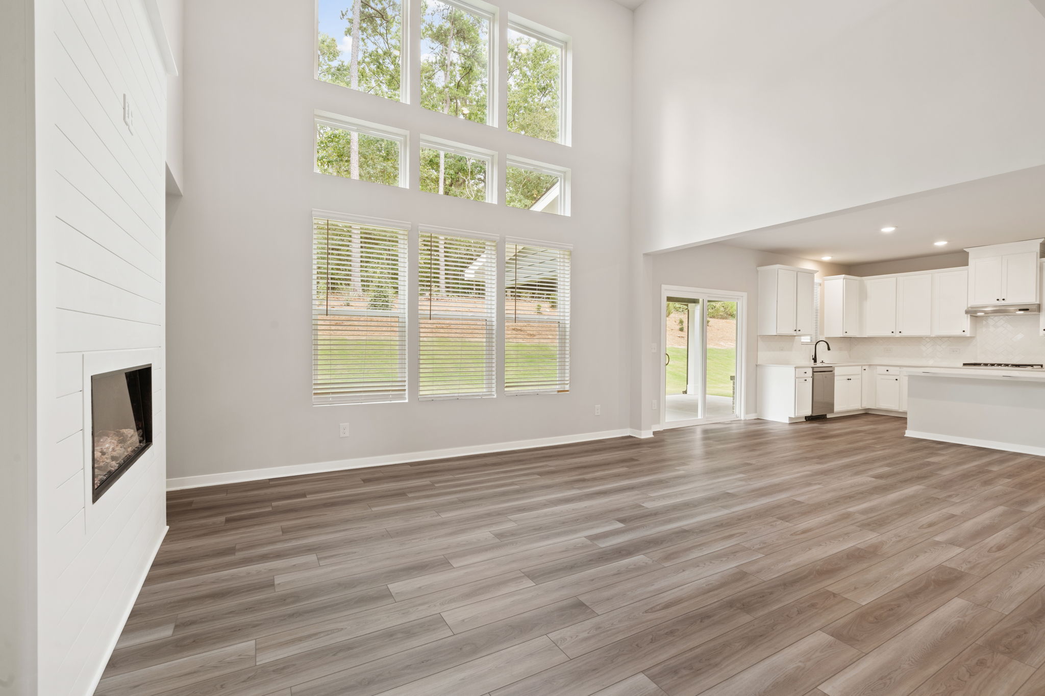 A room with a wood floor and a large window.
