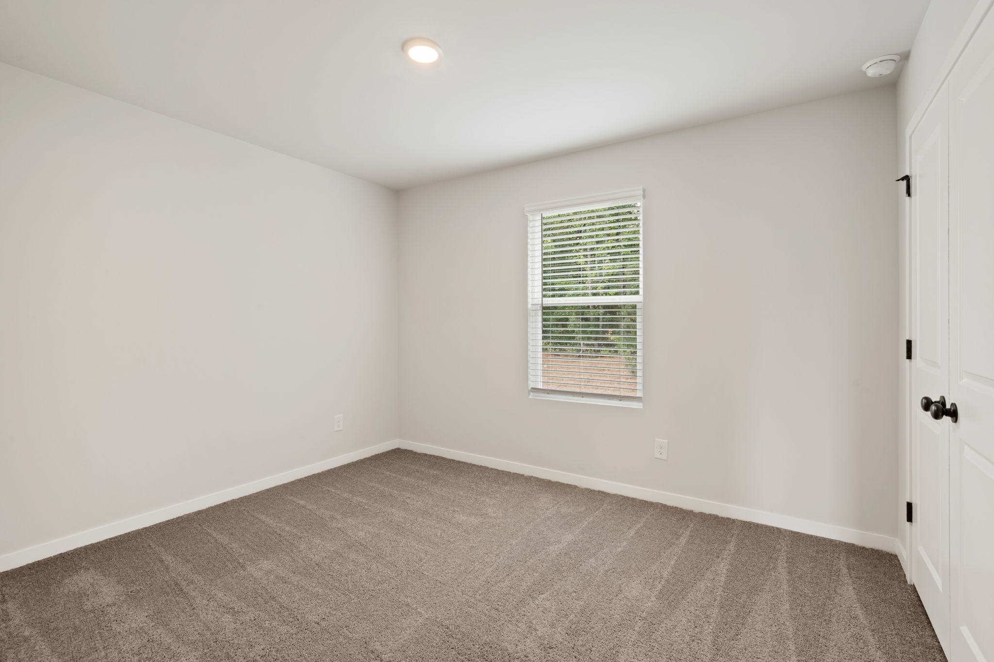 A room with a door and a window.
