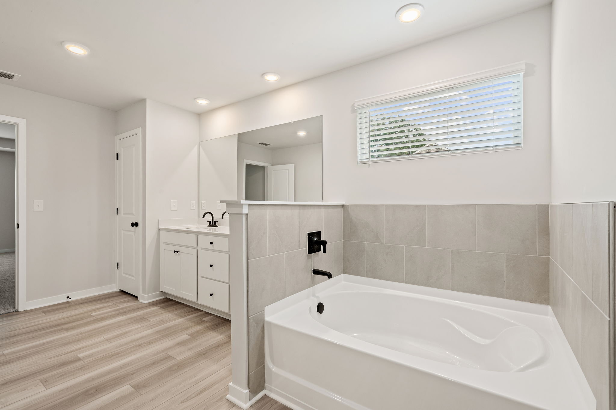 A bathroom with a tub and sink.