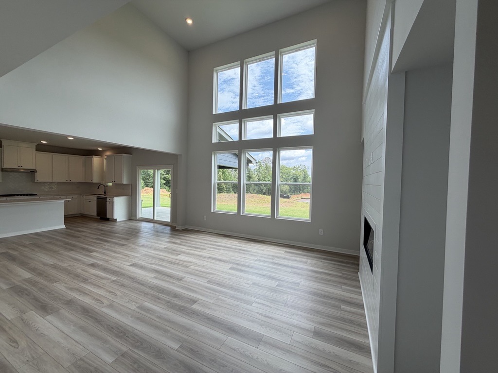 A room with a wood floor and a large window.
