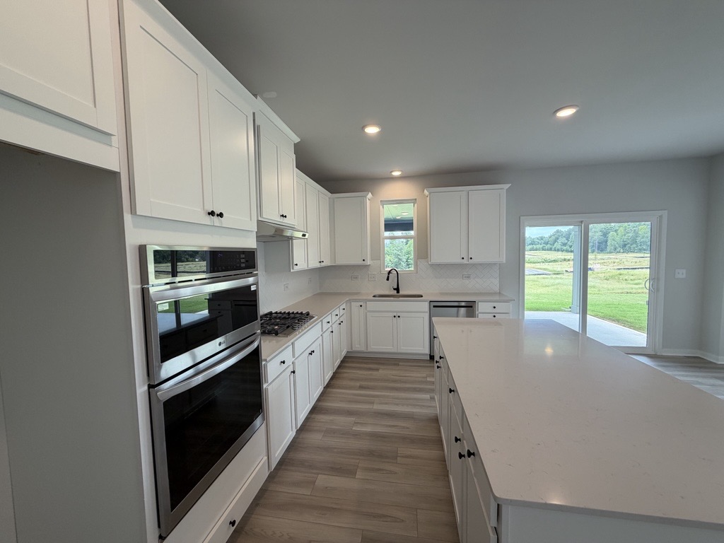 A kitchen with white cabinets.