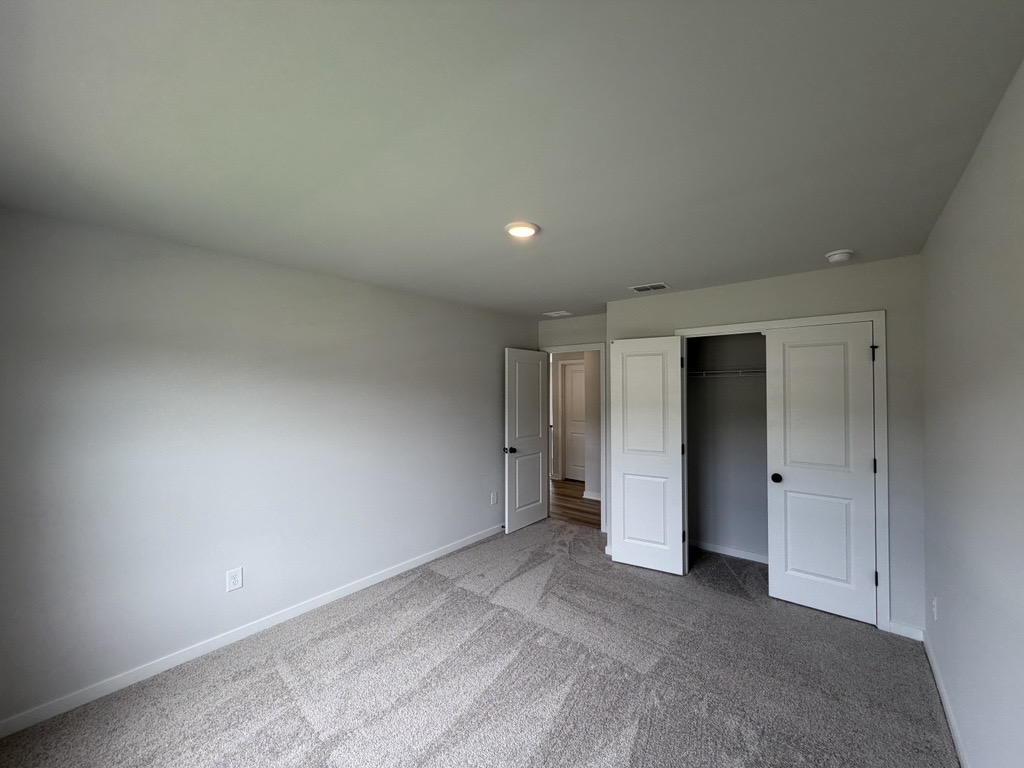 A room with white walls and a carpeted floor.