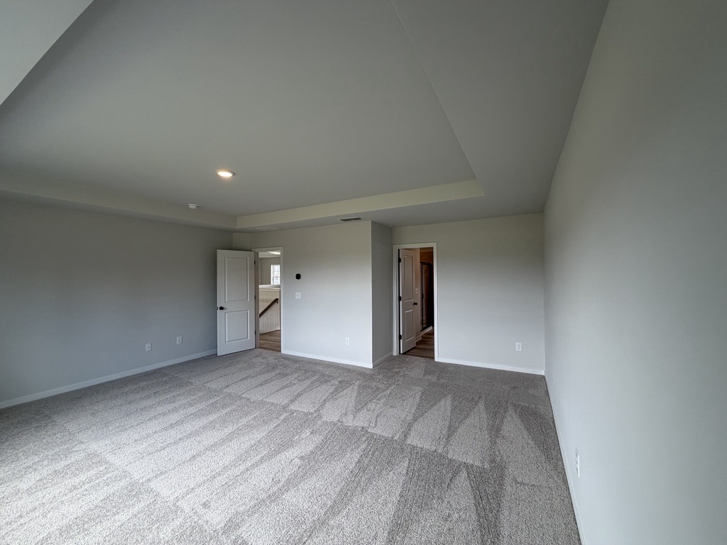 A long hallway with white walls.