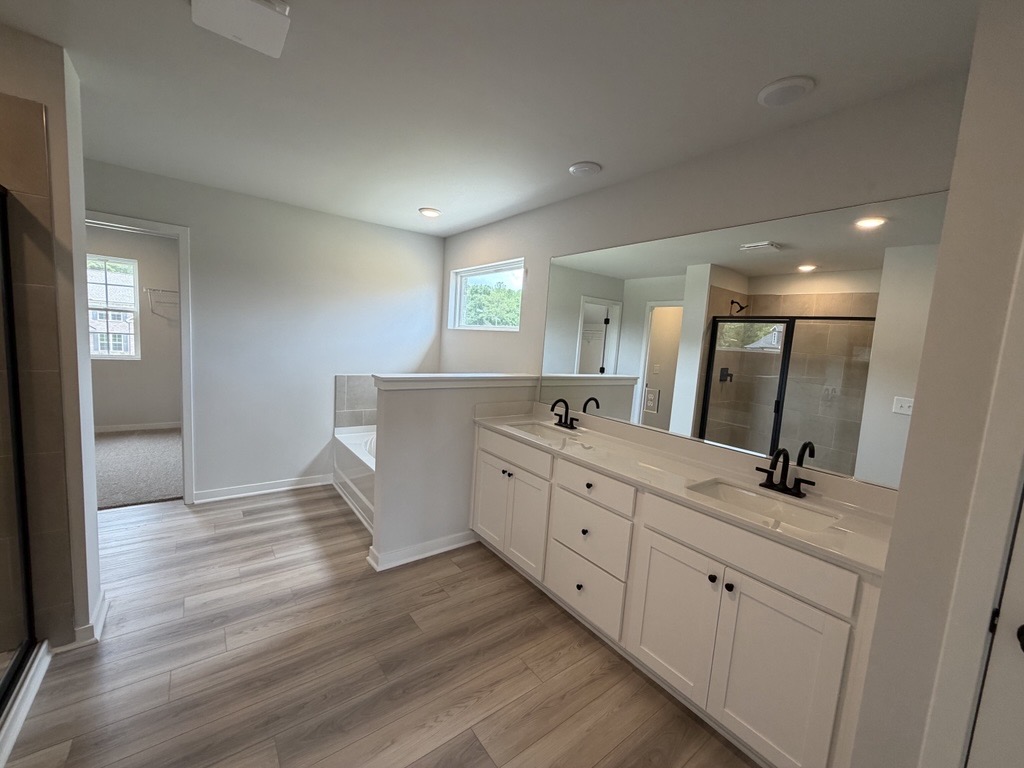 A bathroom with white cabinets.
