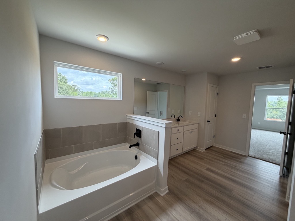 A bathroom with a tub and sink.