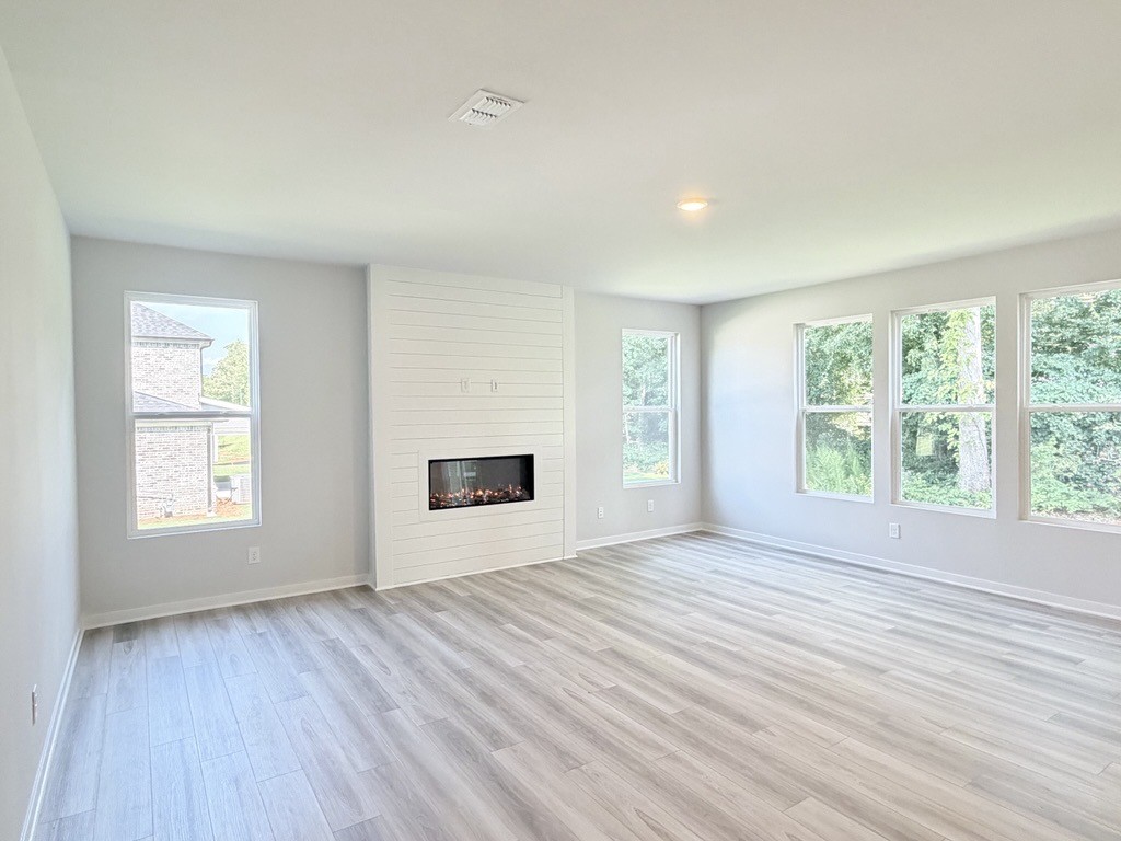 A room with a fireplace and windows.