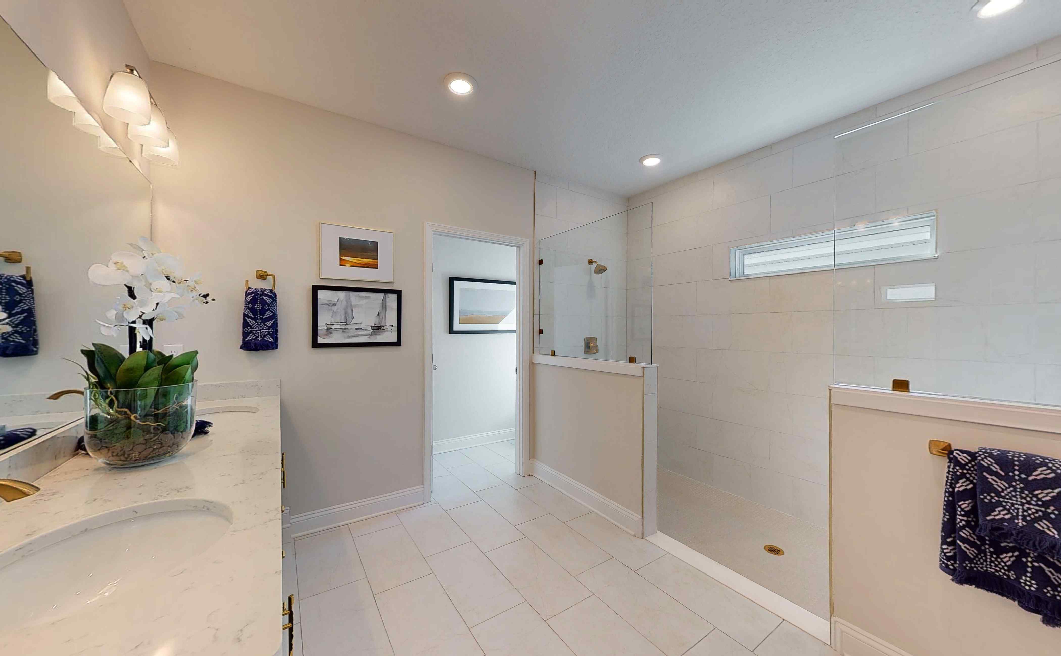 A bathroom with white tile.