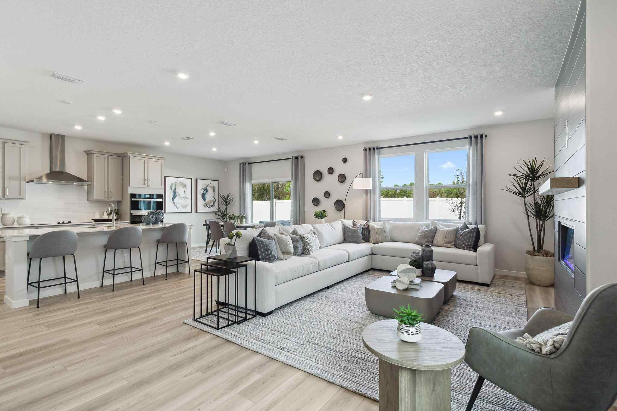 A large living room with a large white couch and a table.