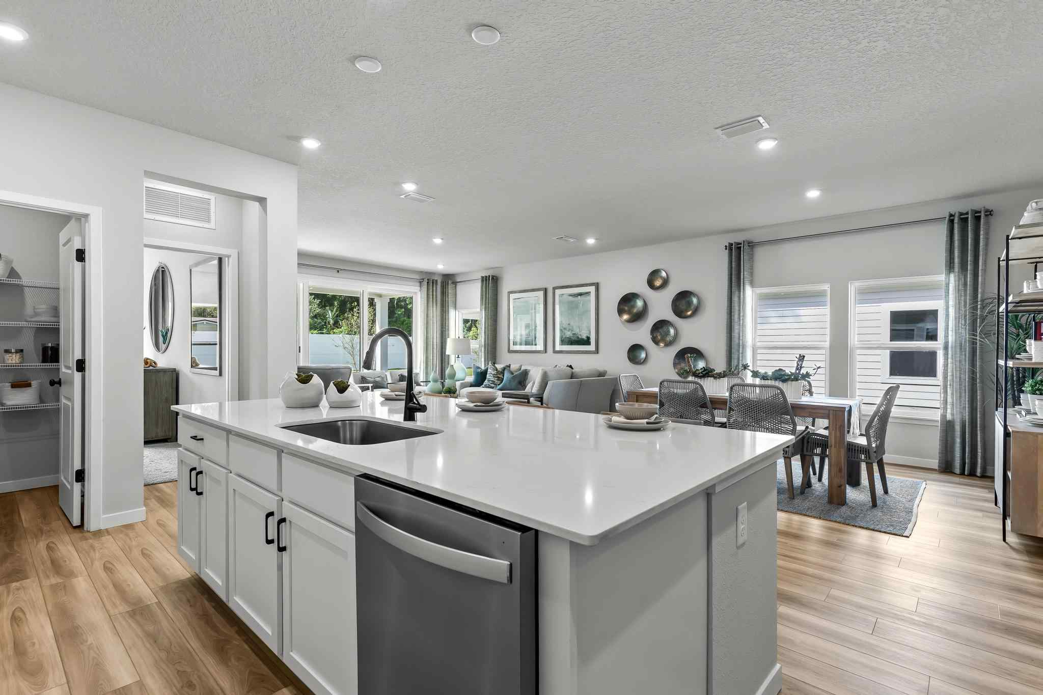 A kitchen with white cabinets.