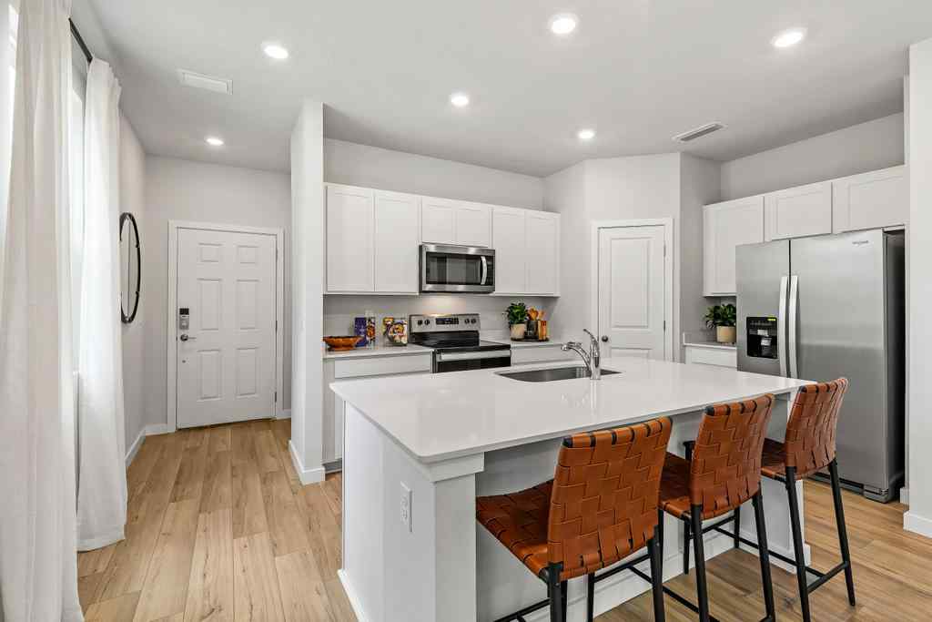 A kitchen with white cabinets.