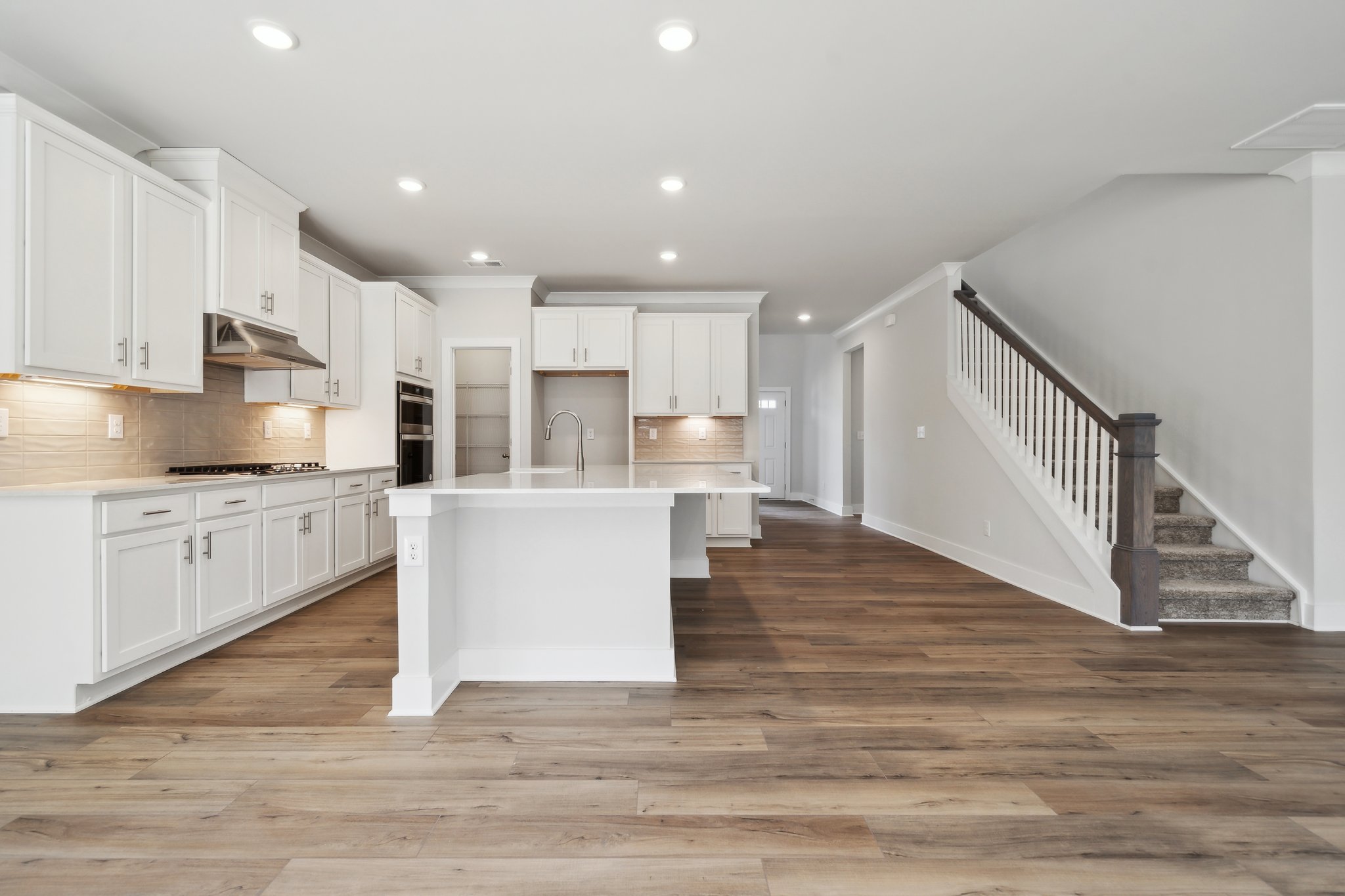 A kitchen with white cabinets.