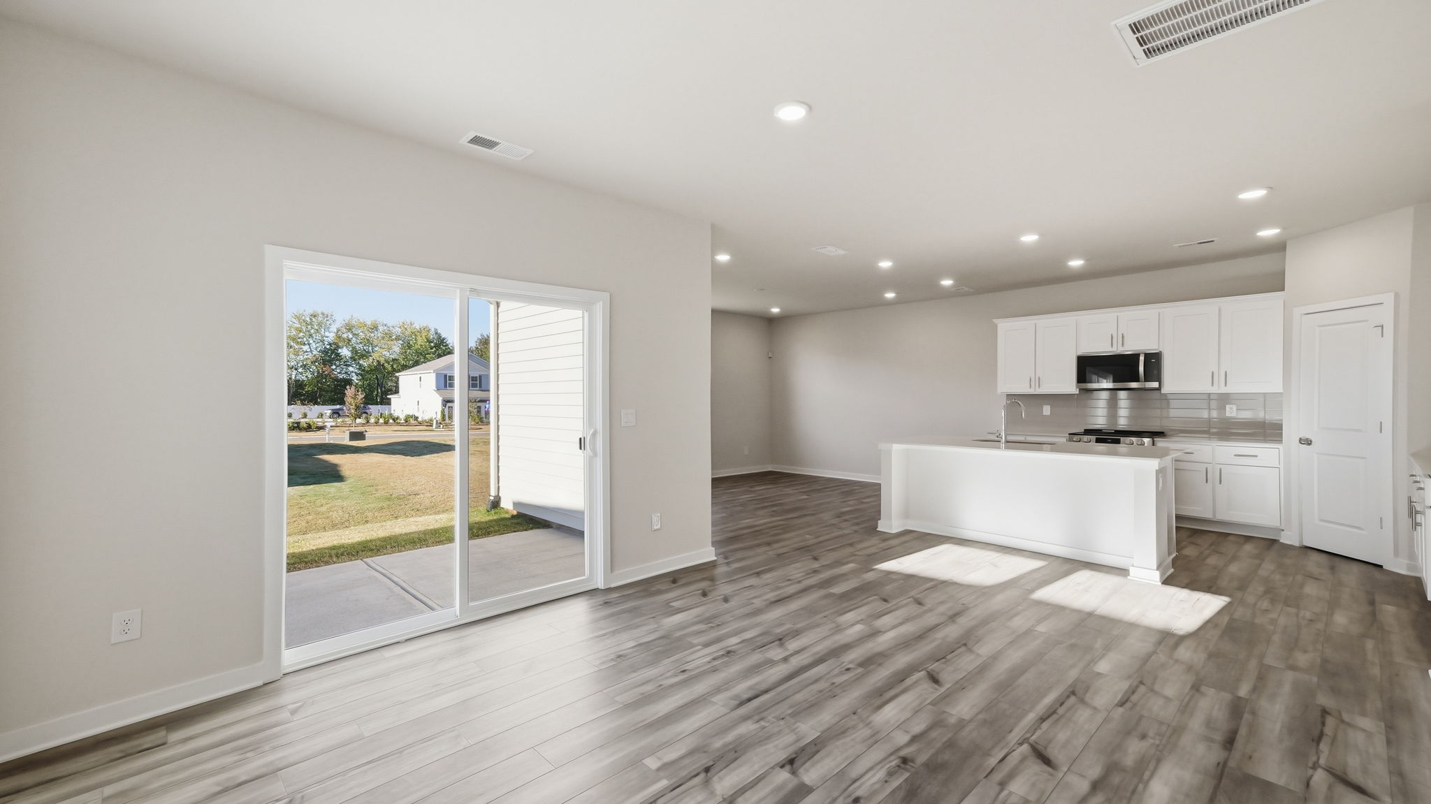 A kitchen with a wood floor.