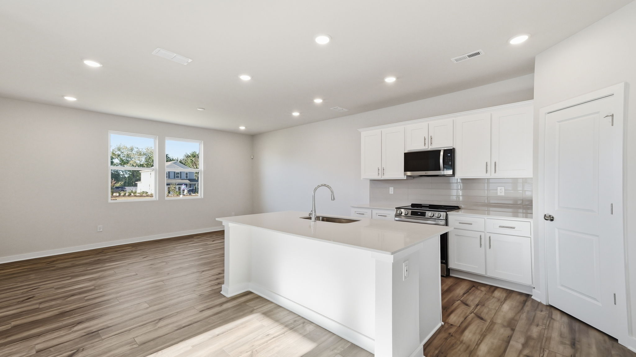 A kitchen with white cabinets.