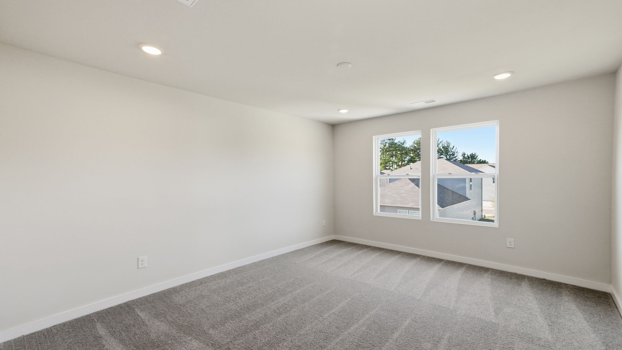 A room with a window and a rug.