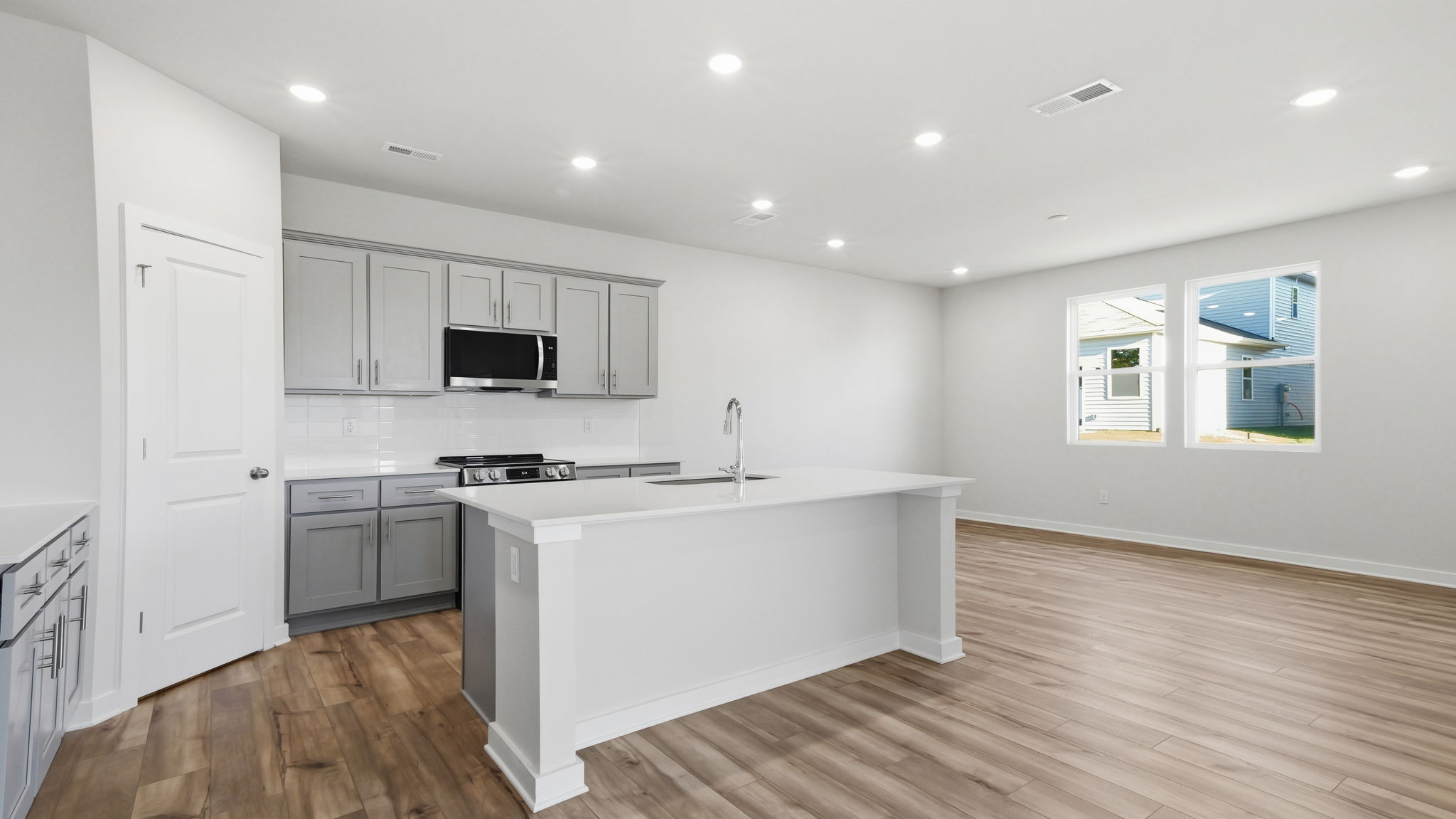 A kitchen with white cabinets.