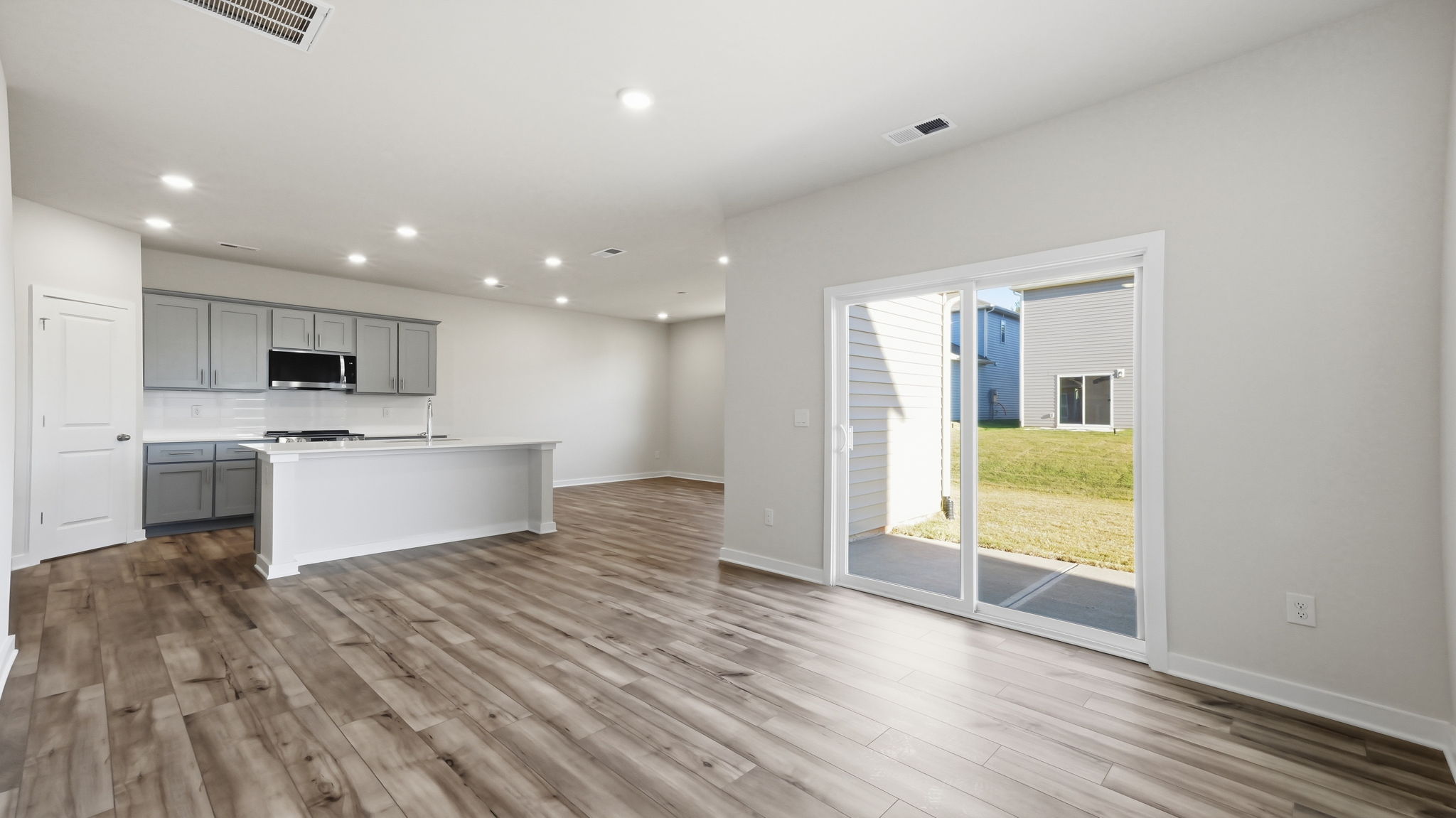 A kitchen with a wood floor.