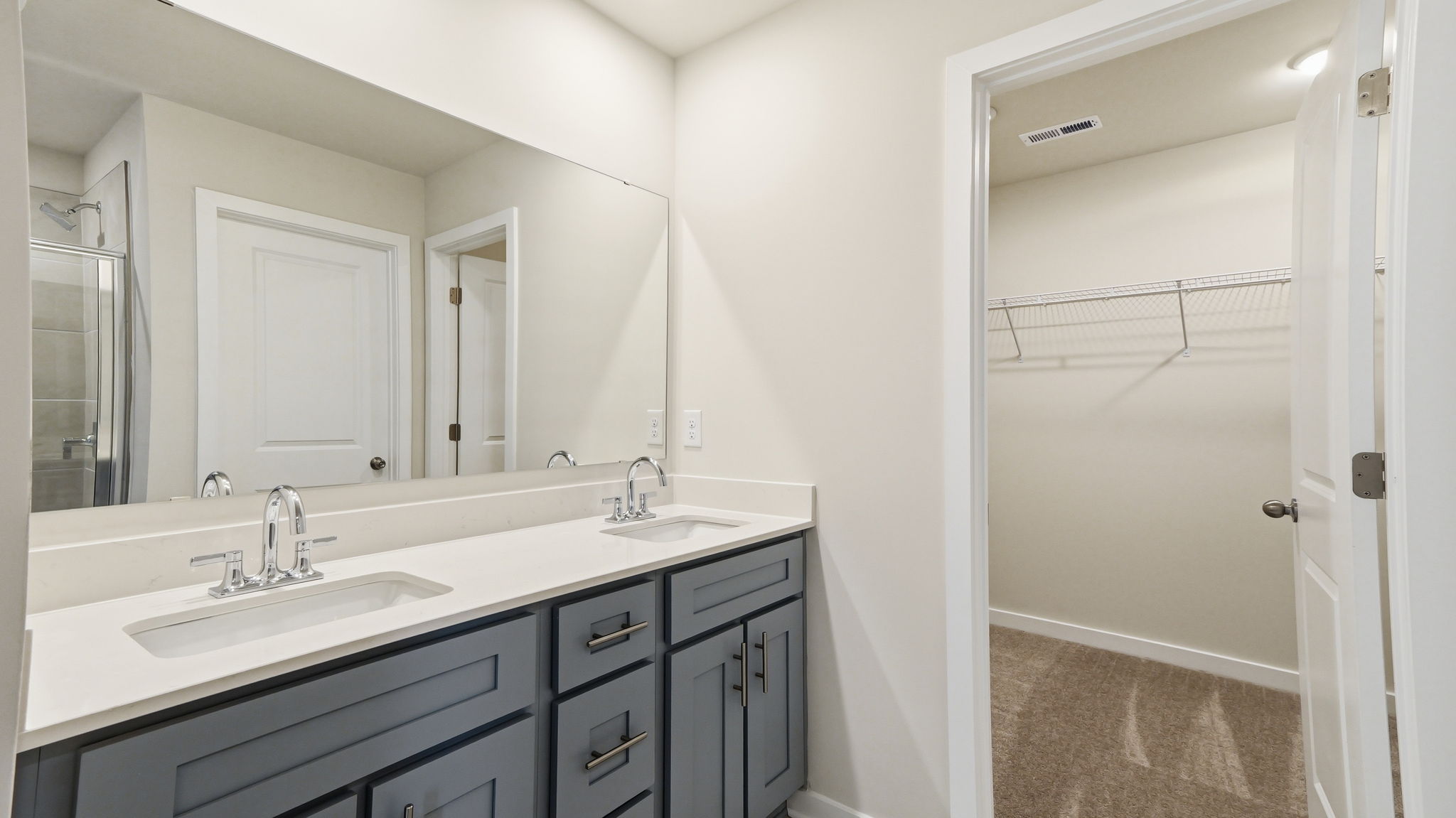 A bathroom with a sink and a shower.