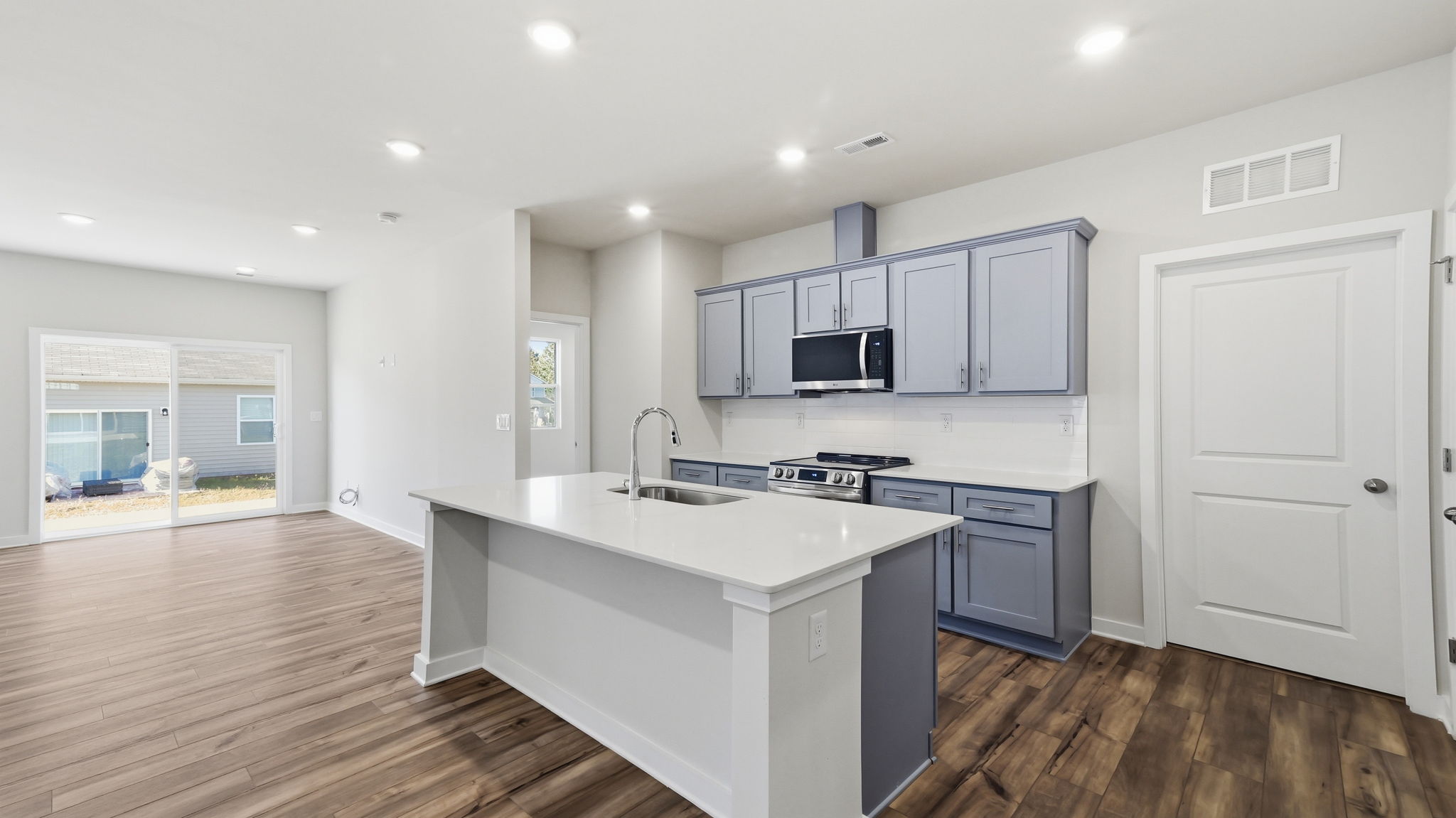 A kitchen with white cabinets.