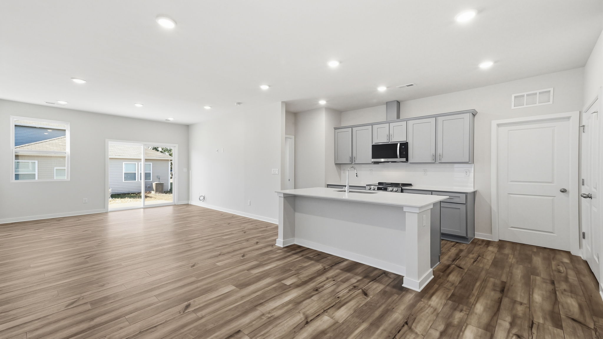 A kitchen with white cabinets.