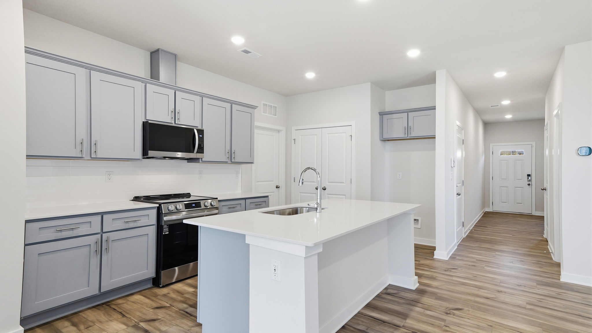 A kitchen with white cabinets.