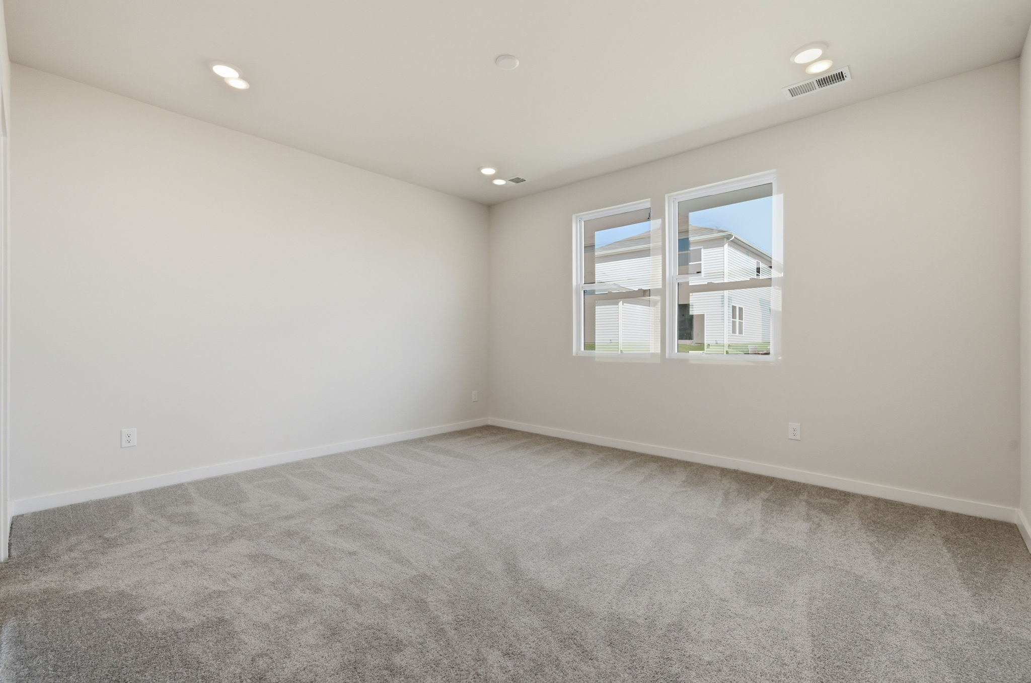 A room with a window and a carpet.