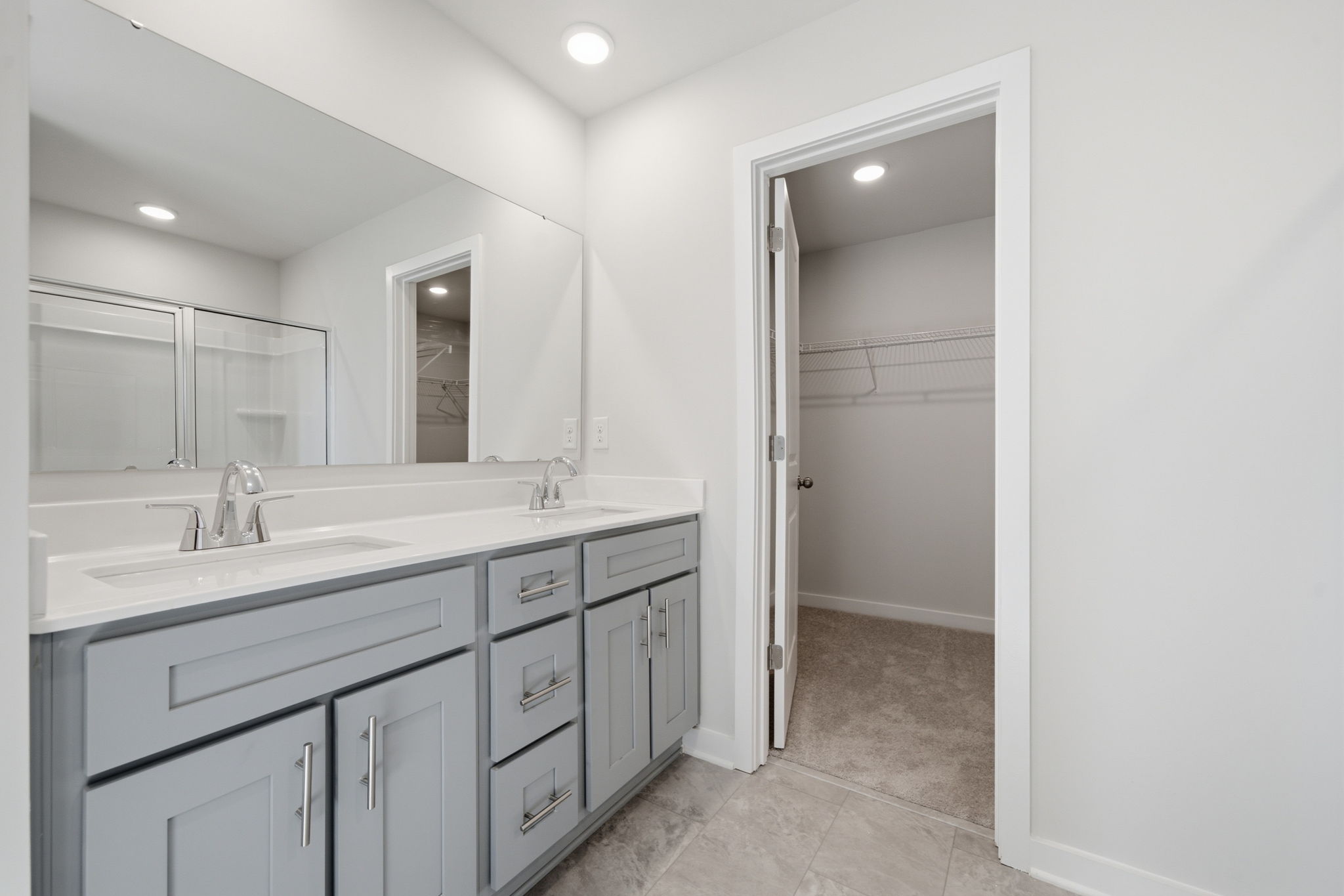 A bathroom with a sink and a shower.