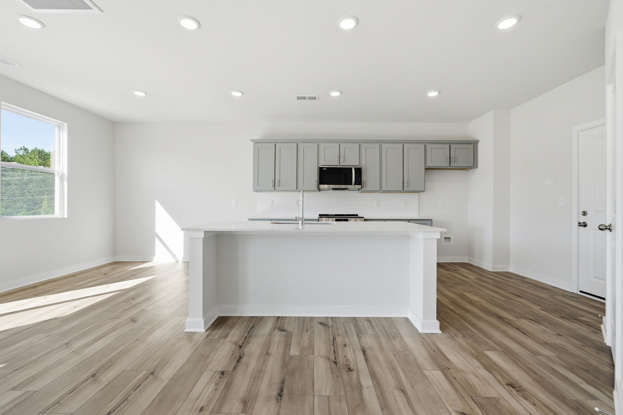 A kitchen with white cabinets.