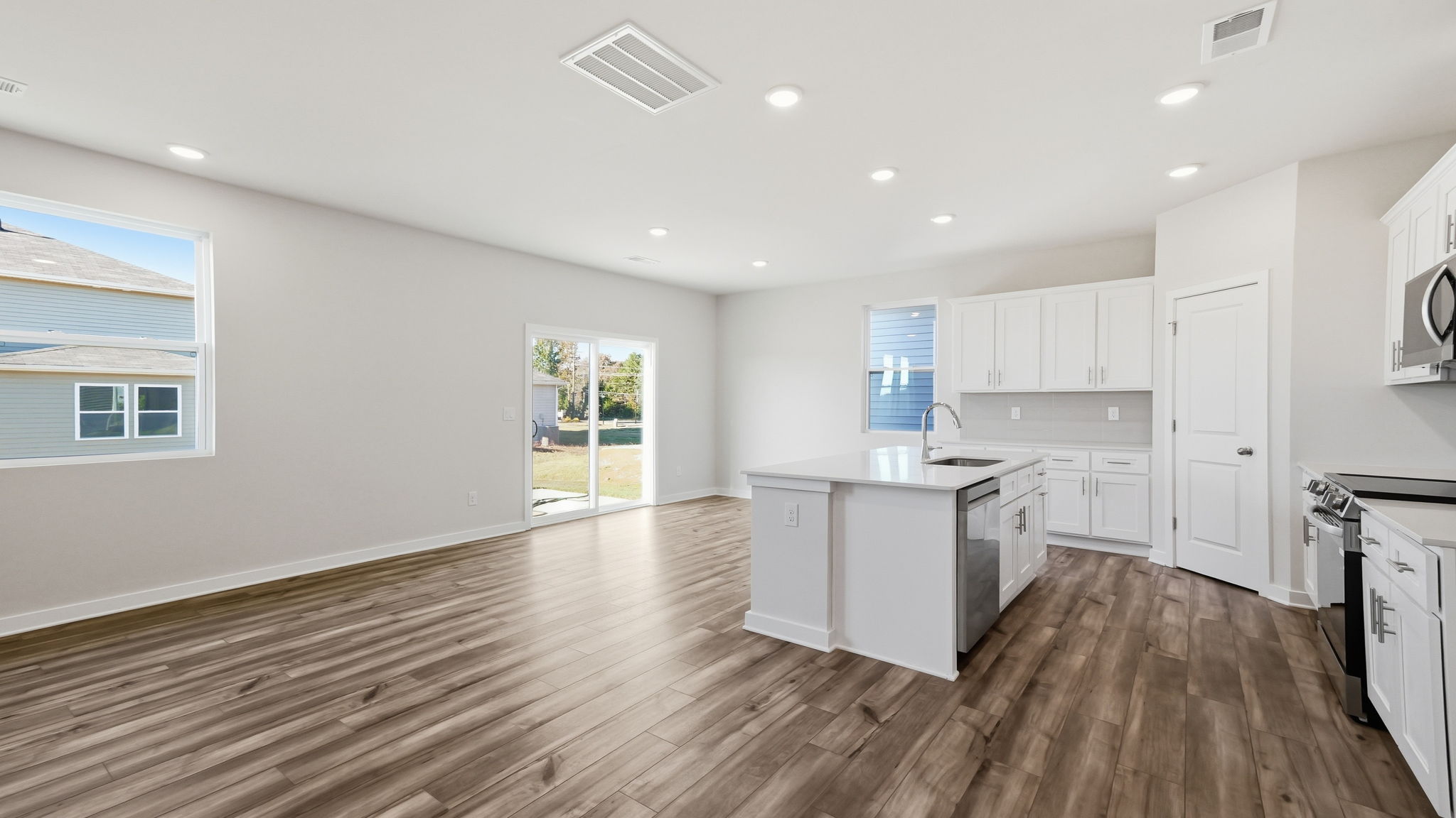 A kitchen with white cabinets.