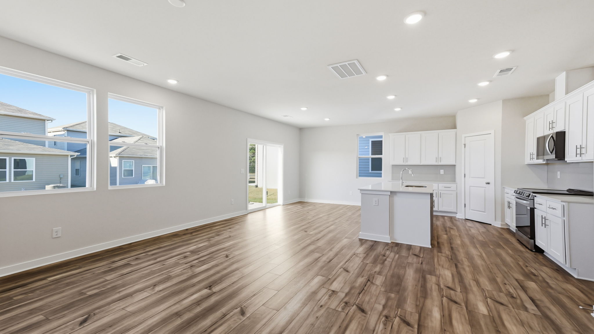 A large kitchen with white cabinets.