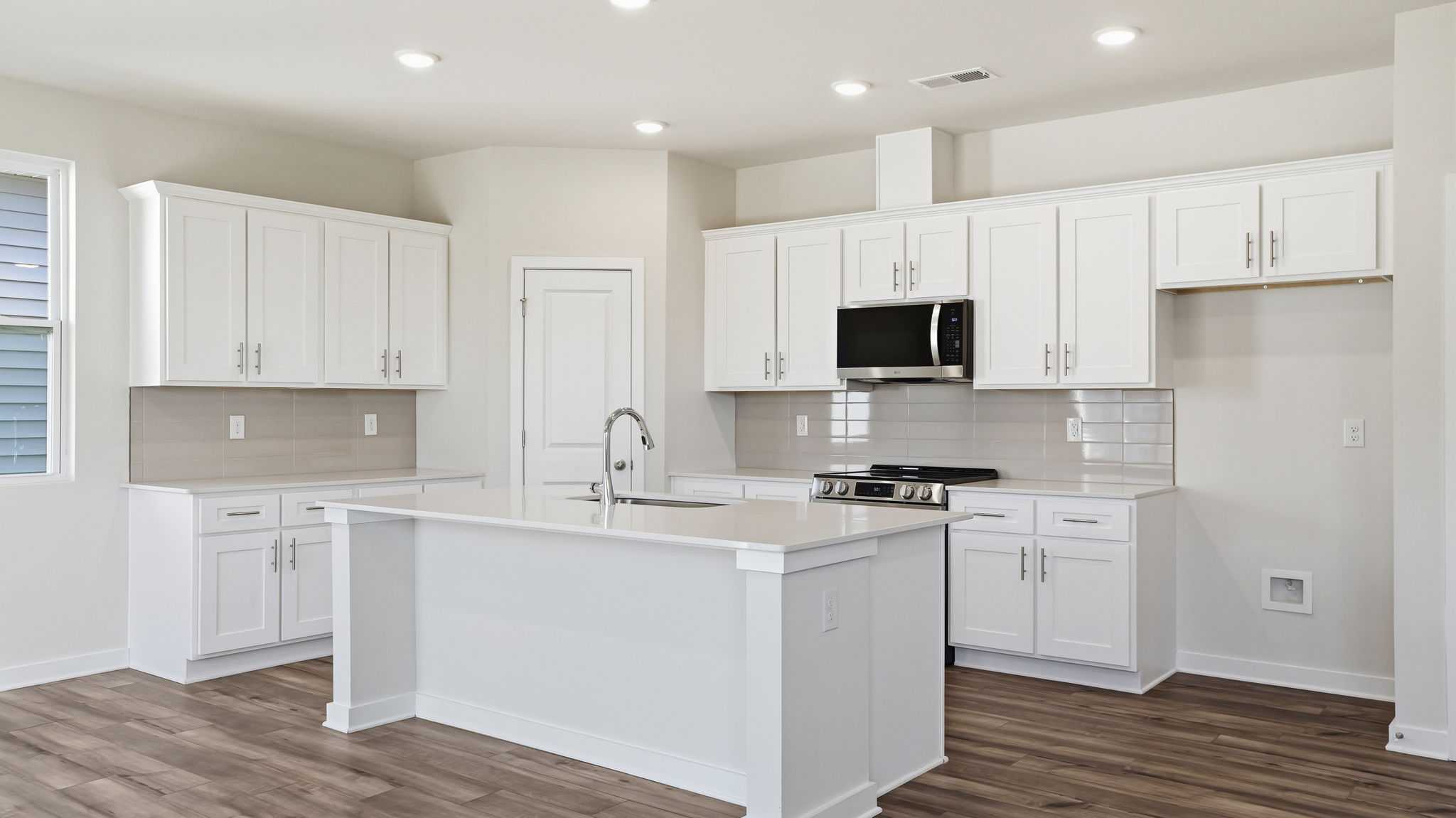A kitchen with white cabinets.