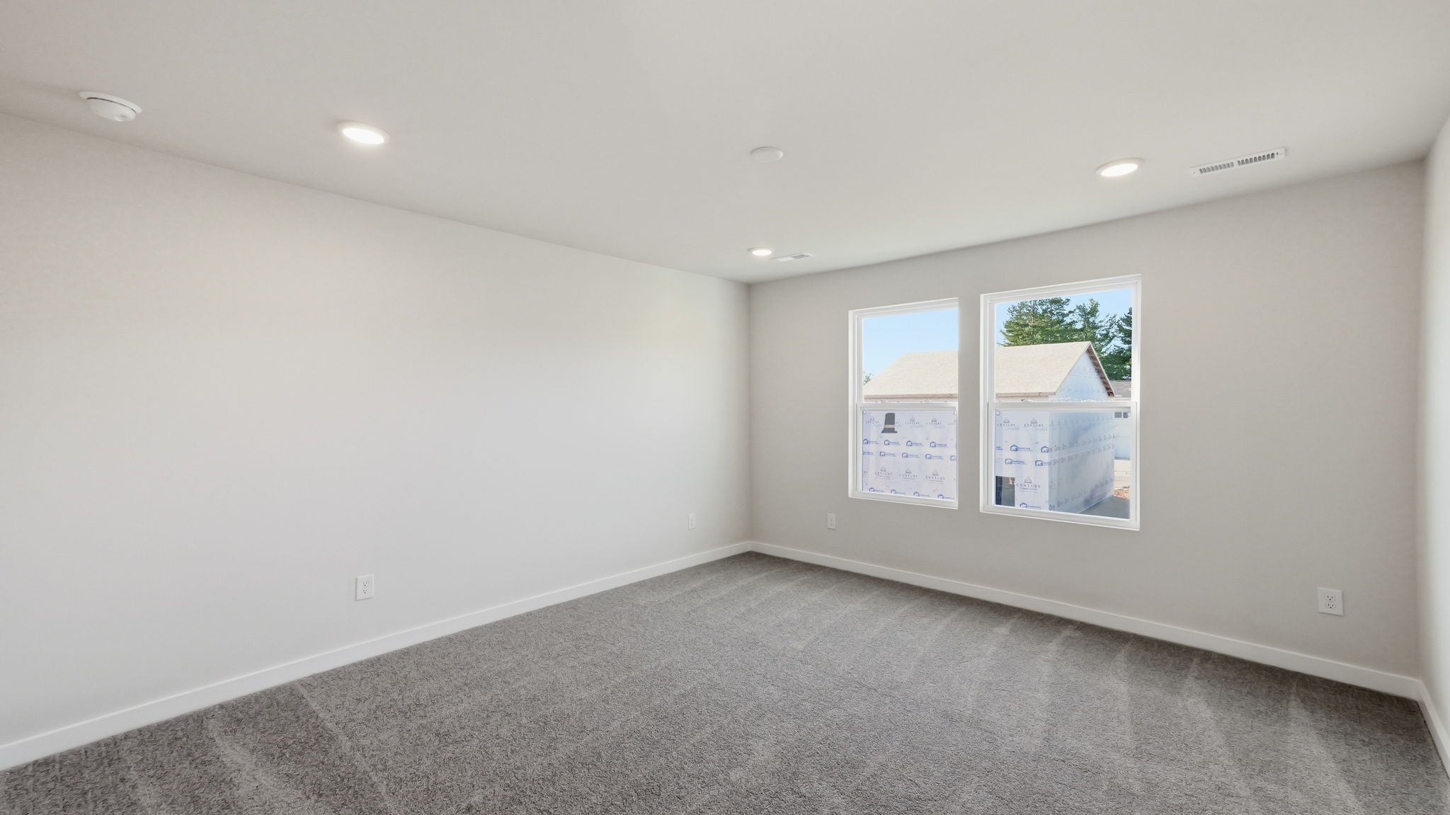A white room with a few pictures on the wall.